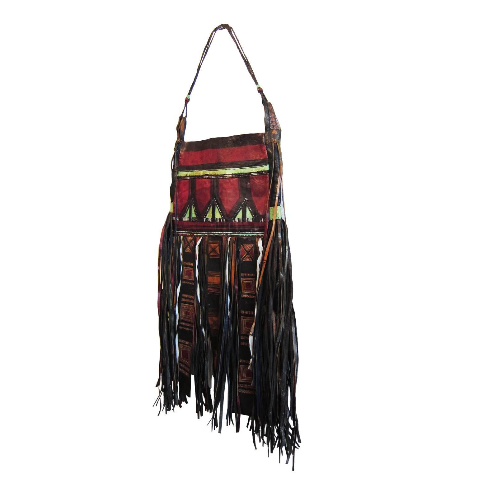 Traditional Tuareg Africa tribally used saharan hand made shoulder bag. 
It is a unique sliding bag with  hand dyed / embroidered / curved leather craft with long fringe. 

Measurments :
22 cm x 33 cm 
Handle : 50 cm 
Fringe : 33 cm

