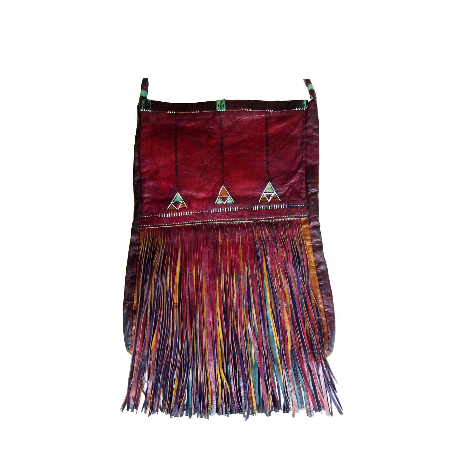 Traditional Tuareg Africa tribally used hand dyed / embroidered / curved leather bag with long fringe.
The Tuareg are Berber people with a traditionally nomadic pastoralist lifestyle. They are the principal inhabitants of the vast Sahara