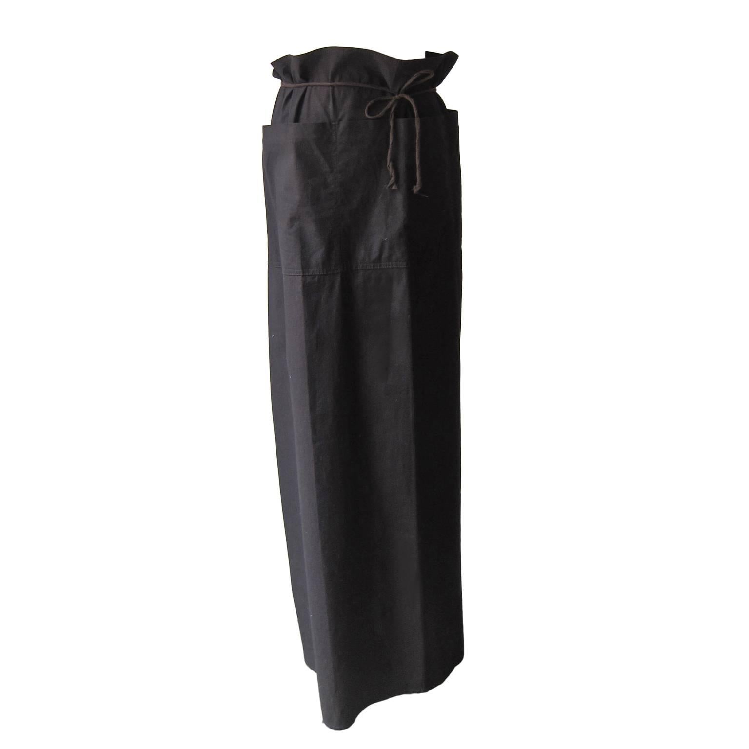 Martin Margiela long wrap skirt with pockets from collection 1998 in very dark brown. It crosses with strings in the back and tie on the front. 
Size 40 Italian

Measurements: 
Width: 100 cm: 
length 104 cm

