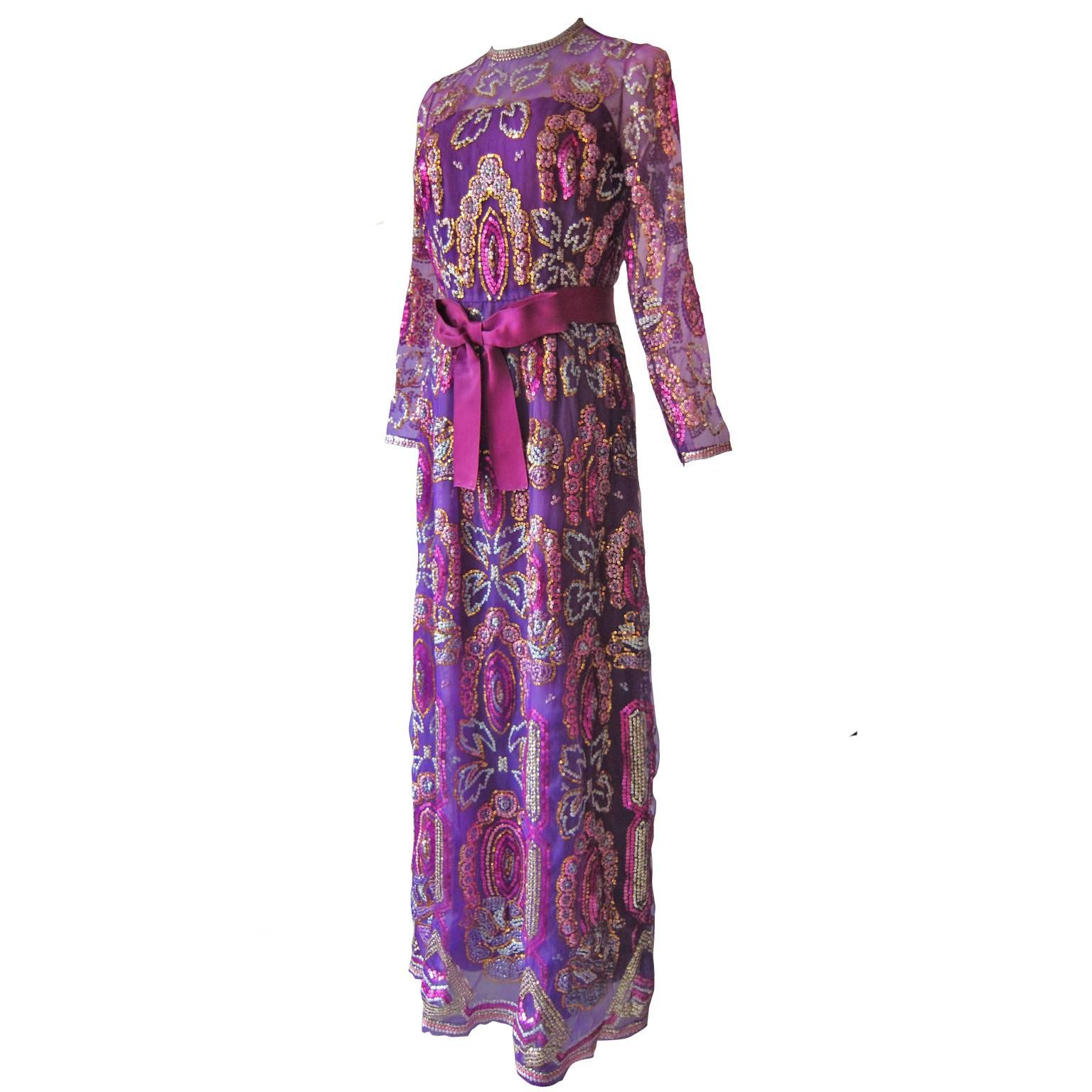 Christian Dior Haute Couture dress by Marc Bohan Automne / Hiver 1971.
An amazing violet evening gown of overall colourful sequin embroidery. 
With satin sash belt.
Fits like size 6 US, 36 - 38 EU
Measurments : 
Waist : 66 cm
Sleeve : 50 cm