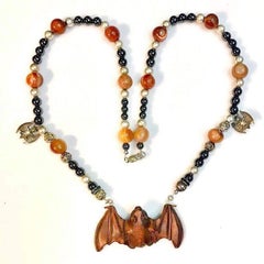 Exolette Agate Necklace Holding a Hand Carved Wooden Netsuke Bat
