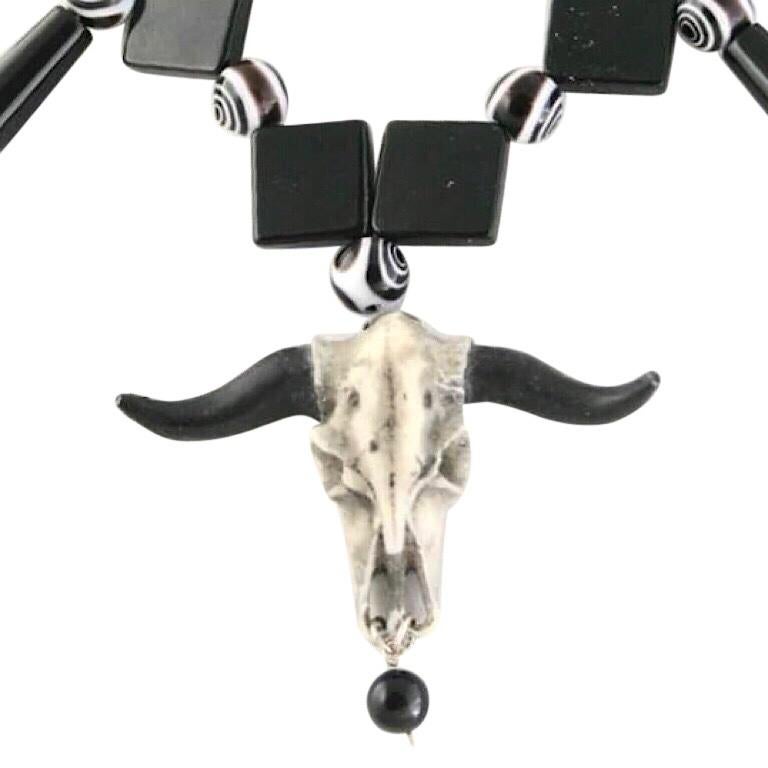 This cow skull pendant necklace is my own original design. I call it “cowgirl at the black and white ball”. It’s where the country and city are friends, acceptable in either location. The skull is cast stone. The black and white round beads are