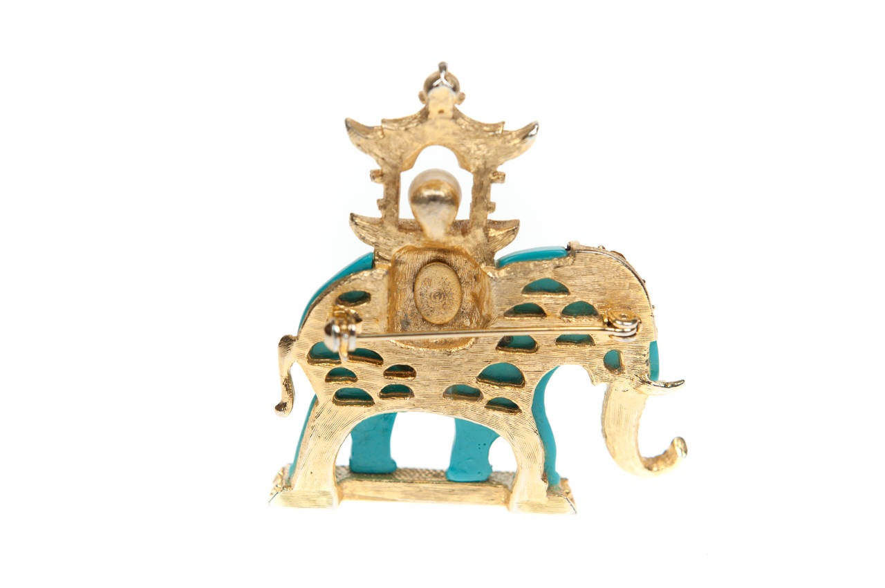 A rare and fabulous Rajah elephant brooch by Hattie Carnegie, the elephant has a canopy (or howdah) on its back.

The body of the elephant is Turquoise Blue thermoplastic, his trunk, tusks, tail, headdress, canopy and the platform he stands on are