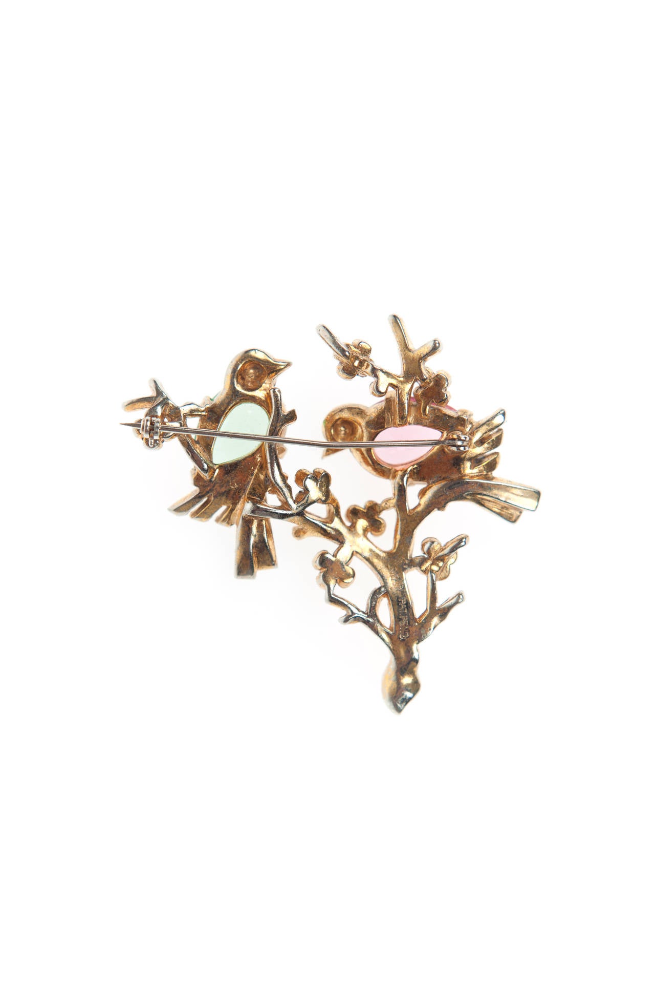 Considered a masterpiece of vintage costume jewellery, designed by Trifari's head designer Alfred Philippe c.1942.

This beautiful pin is Gold plated Rhodium and features two jewelled love birds sitting on a branch.

The Patent for this piece,