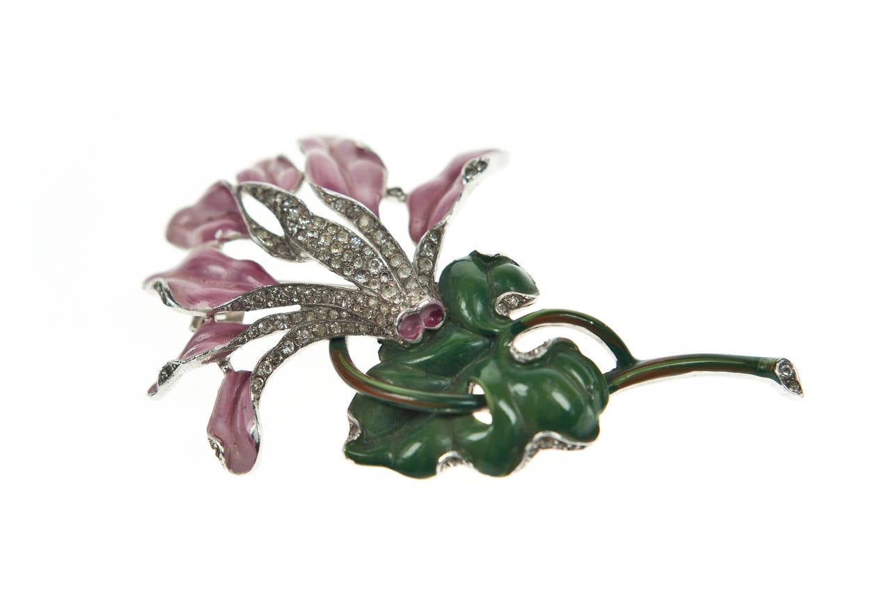 A Stunning and very rare Pink enameled Cyclamen flower fur clip by Trifari.

The large clip is Rhodium plated and hand painted with enamel, elements of the incredibly naturalistic three dimensional design are highlighted with pave set rhinestones.