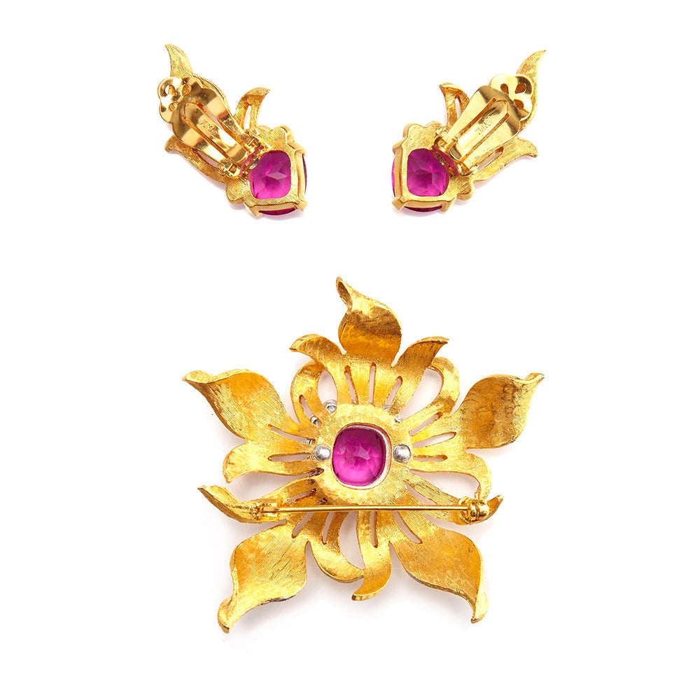 A stunning brooch and earrings set of brushed Florentine gold tone finish.
The brooch measures 6.5cm x 6.5cm, the matching clip on earrings measure 3.5 x 1.7cm.

Marked: Jomaz

About the Designer:

Jomaz 1946-1976
In 1946 Joseph Mazer left