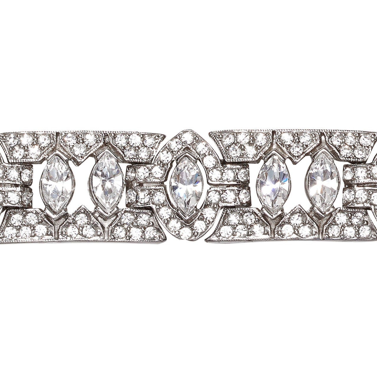 Striking Ciner rhodium plated silvertone bracelet made up of 12x articulated panels, pave set with clear Swarovski crystal rhinestones, in an alternating Art Deco inspired geometric design.

Marked: Ciner (c)