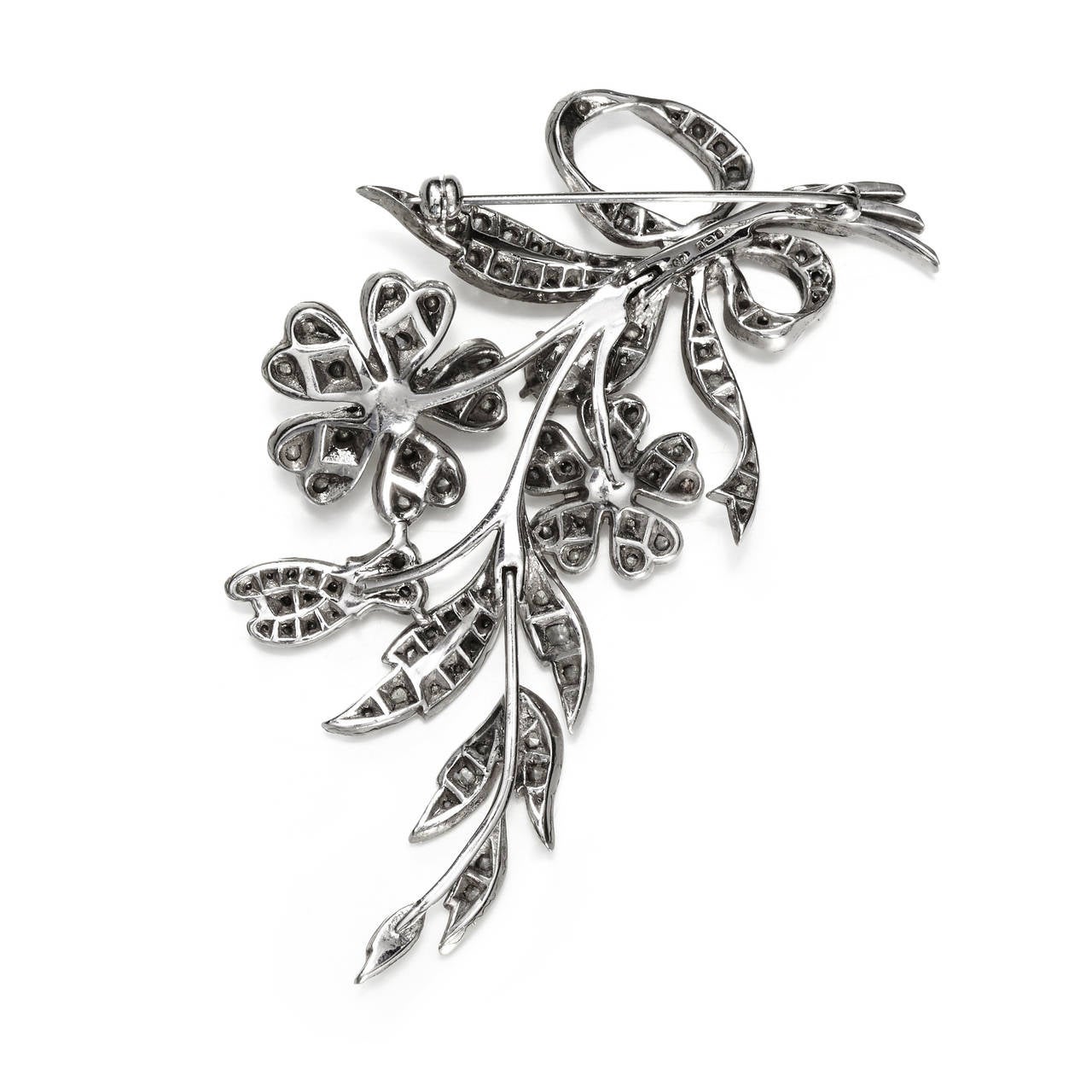 A lovely floral spray brooch in a classic feminine design by English costume jeweller Ciro Pearls.

Made of sterling silver set with crystal rhinestones in a delicately articulated design made up of three pieces, fully hallmarked.

Marked: