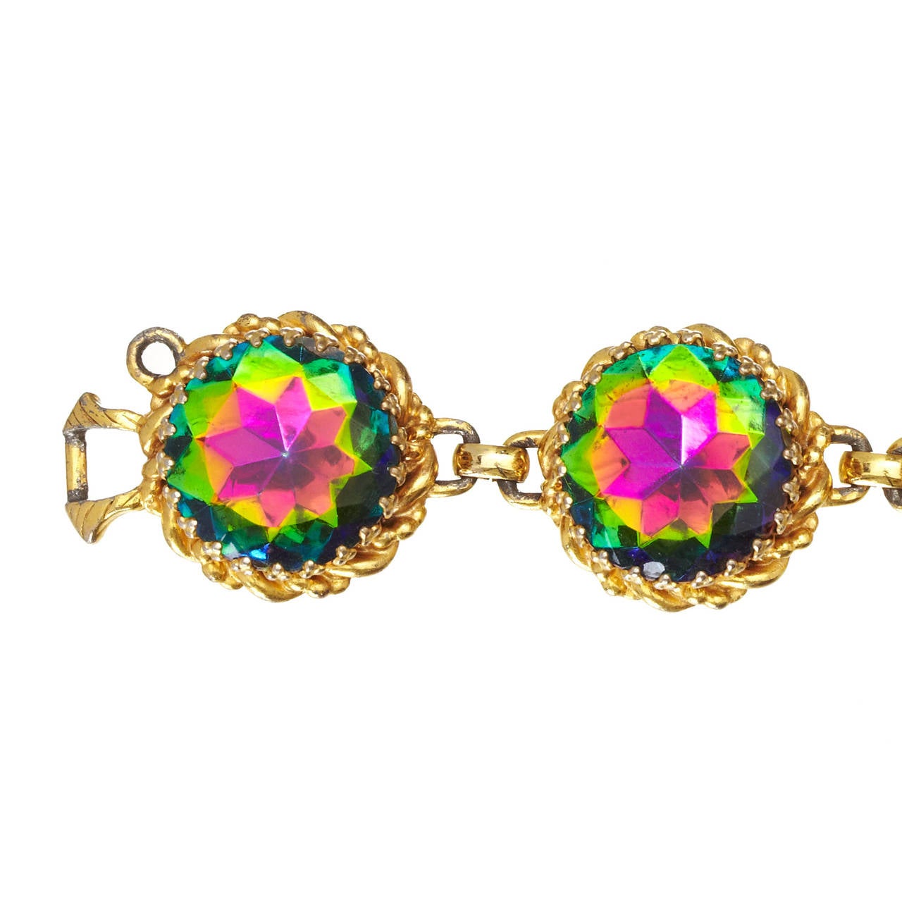 An iconic design by Schiaparelli this is the so called Watermelon Tourmaline bracelet and matching earrings.

The bracelet is made up of 6 large Vitrail Medium Swarovski crystals rhinestones set into gold plated crown settings, surrounded by a