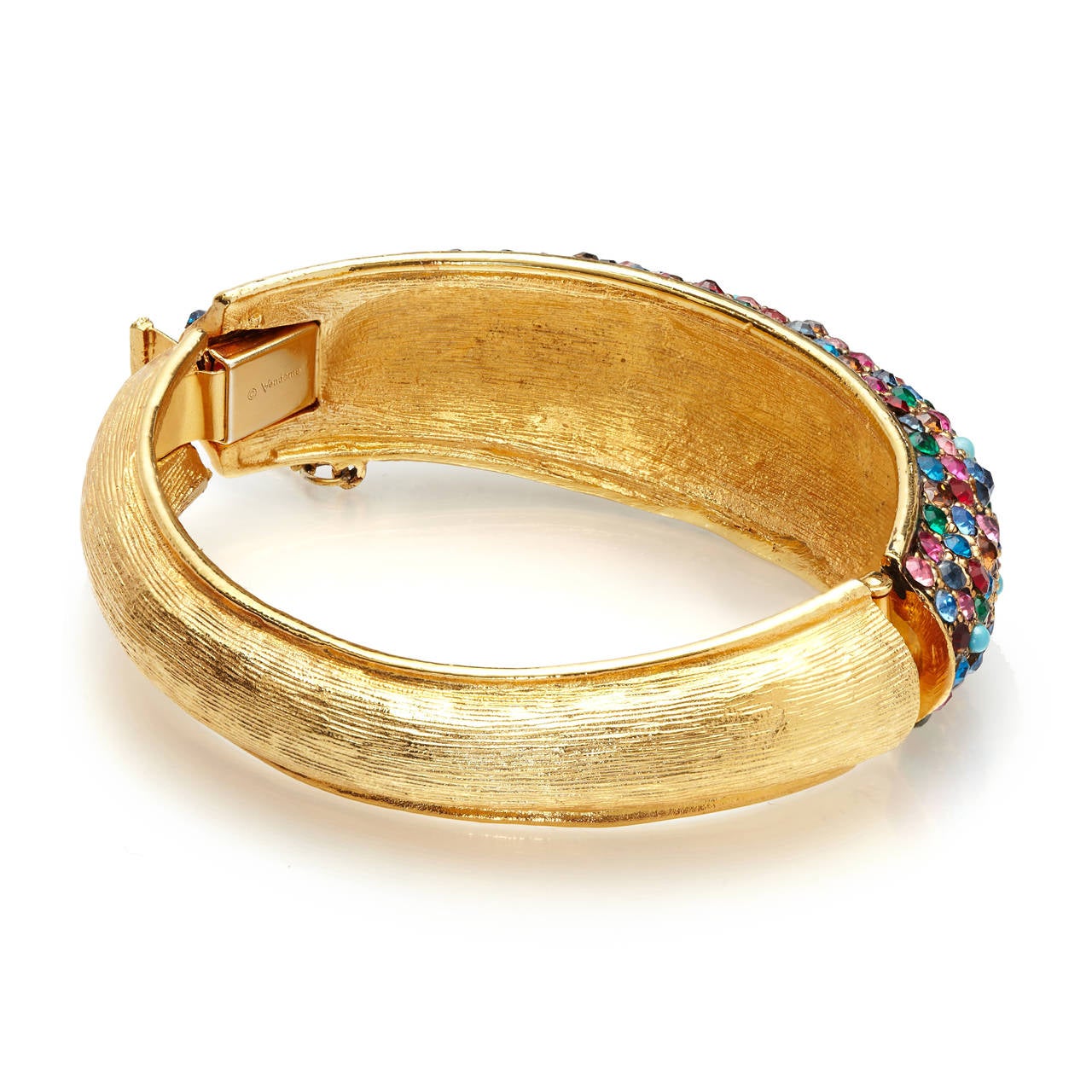 Solid and beautifully crafted heavily gold plated bangle by Vendome, the high-end jewellery line made by Coro. The bangle is hinged making it easy to put on and take off. The bottom half is textured gold and the top half is encrusted with