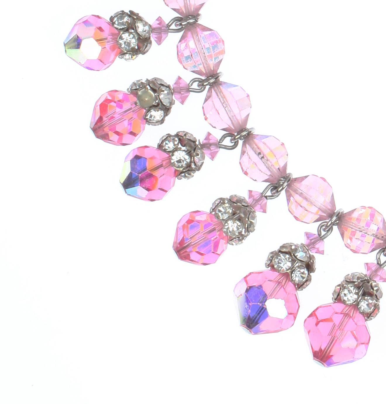 A stunning Chocker composed of Vintage Pink Swarovski AB faceted crystals and Silvertone rhinestone bead caps, c.1955.
Made by Coro for their most exclusive jewellery line, Vendome.
The necklace is 35cm long with a 5cm extension chain, finished