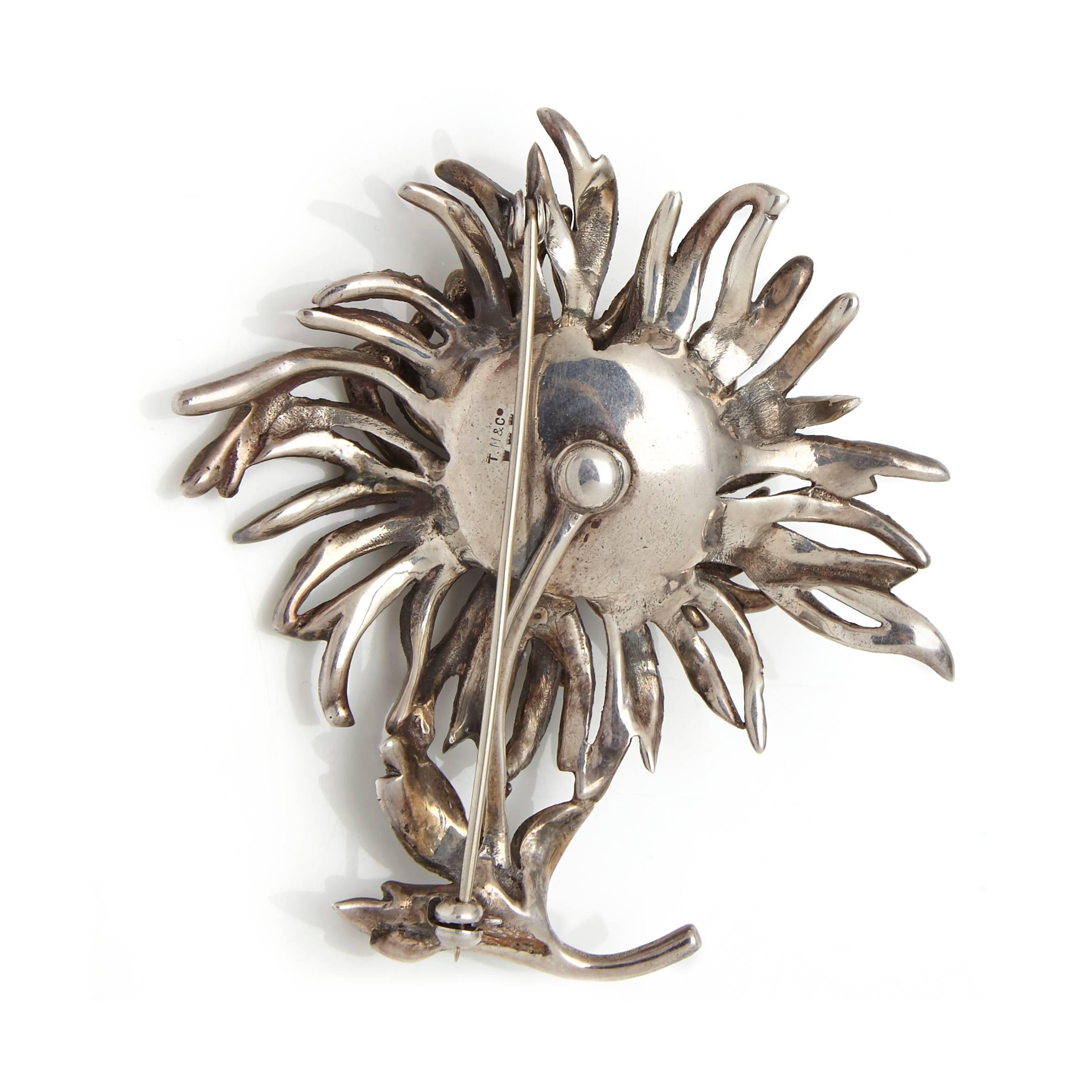 This beautifully observed sterling silver piece was designed by English silversmith Thomas L.Mott. It depicts an outward curving Chrysanthemum flower. The piece is solid but remains delicate, each petal is pave set with marcasite stones. A lovely