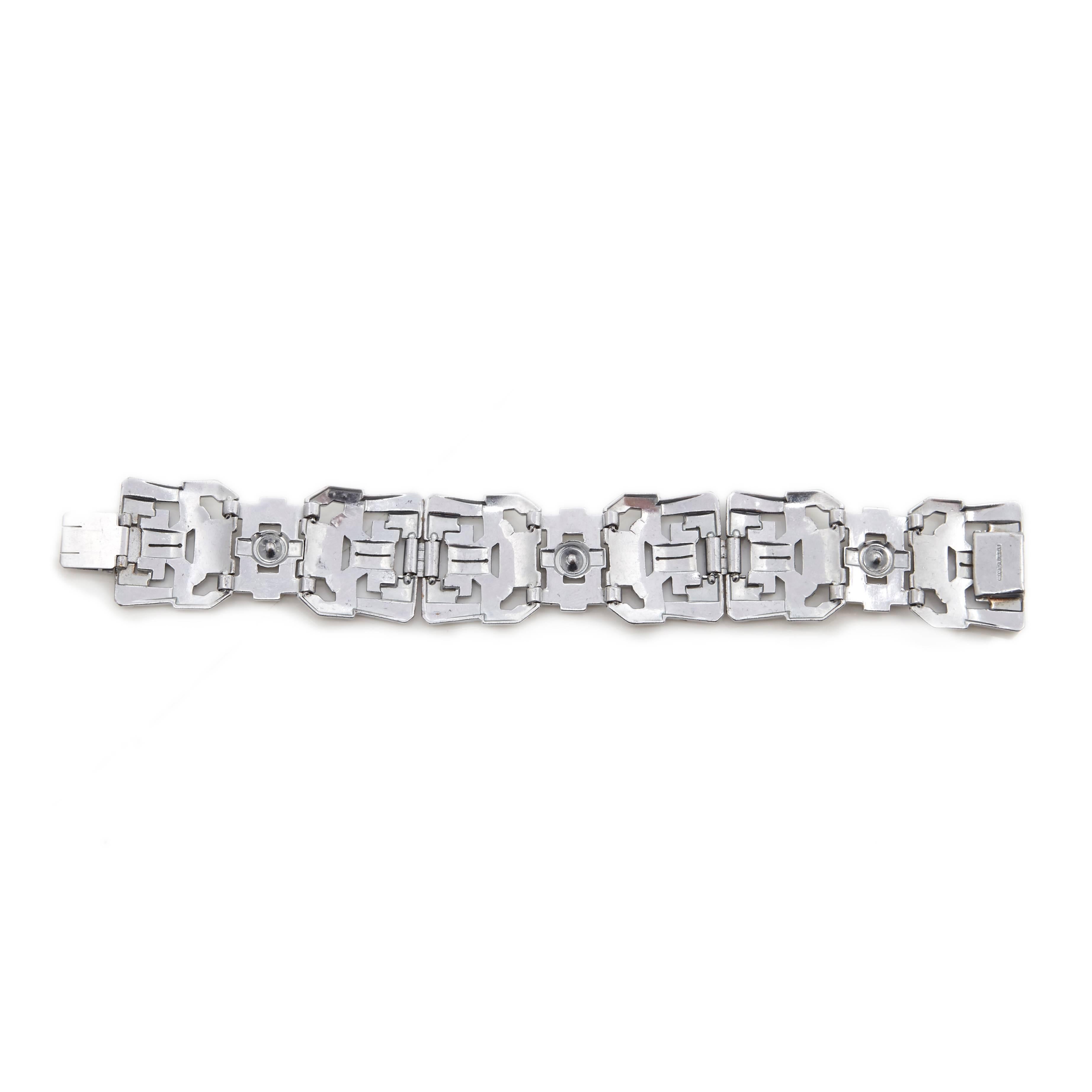 One of the most fantastic Art Deco bracelets we have ever had.

This rare wider width bracelet measures 18cm long, 2.5cm wide.

A genuine Gatsby era bracelet, chrome set with crystal rhinestones and baguettes in a classic pierced openwork