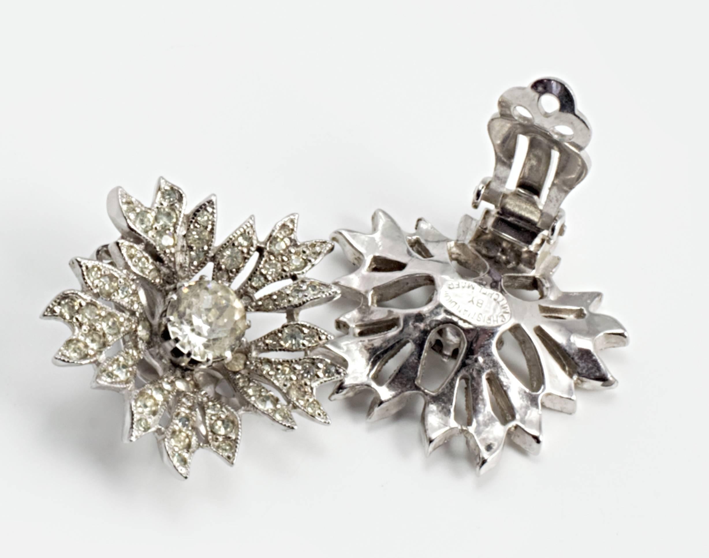Stunning and sought after 1950's Dior earrings in the shape of open flowers, Rhodium plated and set with crystal rhinestones.

Mitchel Maer is the most collectable name in jewellery from the house of Dior. During his time designing for Dior, he