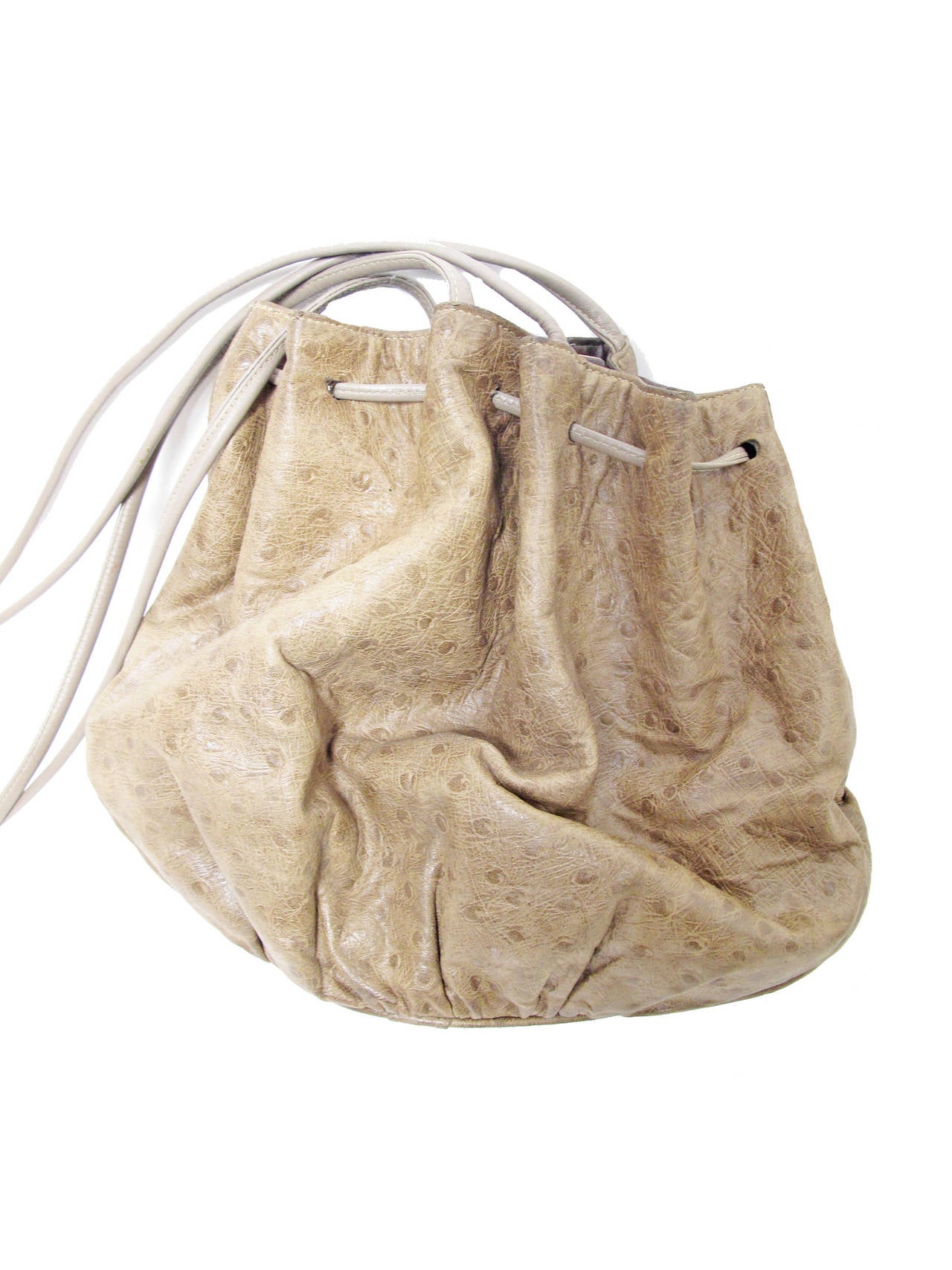 Halton brown stamped leather shoulder bag with drawstring closure.  Strap length 18