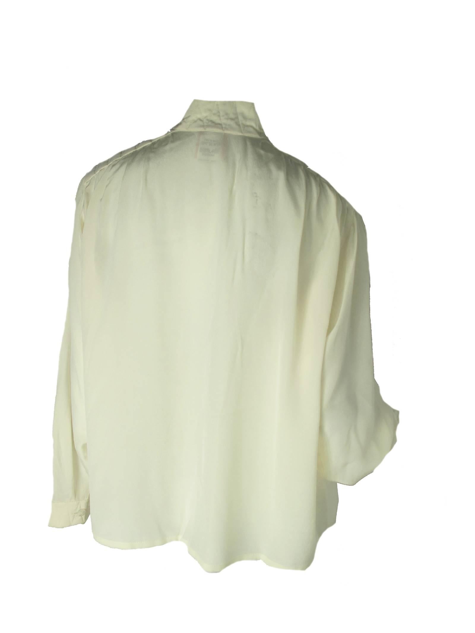 Krizia cream silk blouse with stitching details on shoulders.  Condition: Very good. 
Size Large

We accept returns for refund, please see our terms.  We offer free ground shipping within the US.
