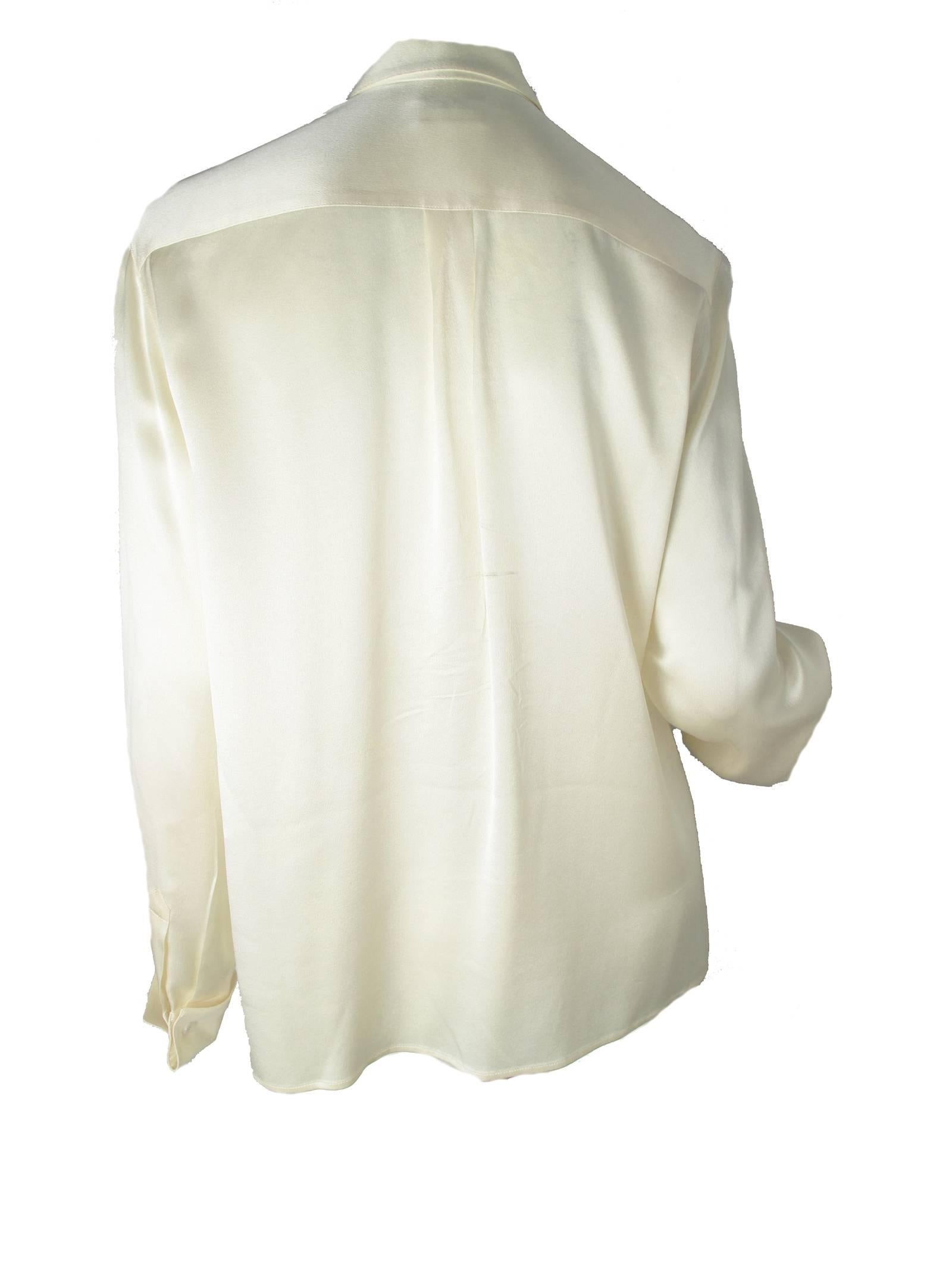 Chanel cream silk long sleeve double front button, french cuffs.  Condition: Very good. Size 40 / US 6 - 8 

We accept returns for refund, please see our terms.  We offer free ground shipping within the US.  Let us know if you have any questions.