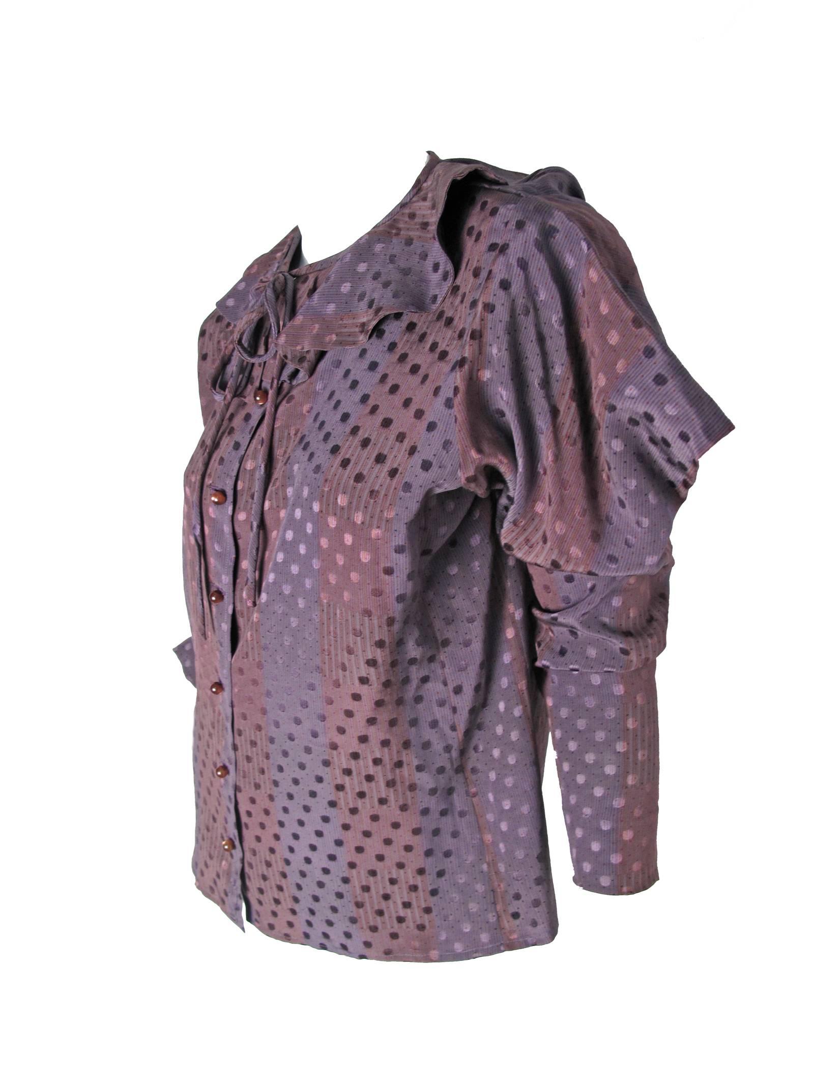 1970s Ungaro purple silk blouse with stripe and polka dot print, ruffle at collar and tie.  Buttons down front, interesting sleeves. 
Condition: Excellent. Size 14 / or current US Large
41