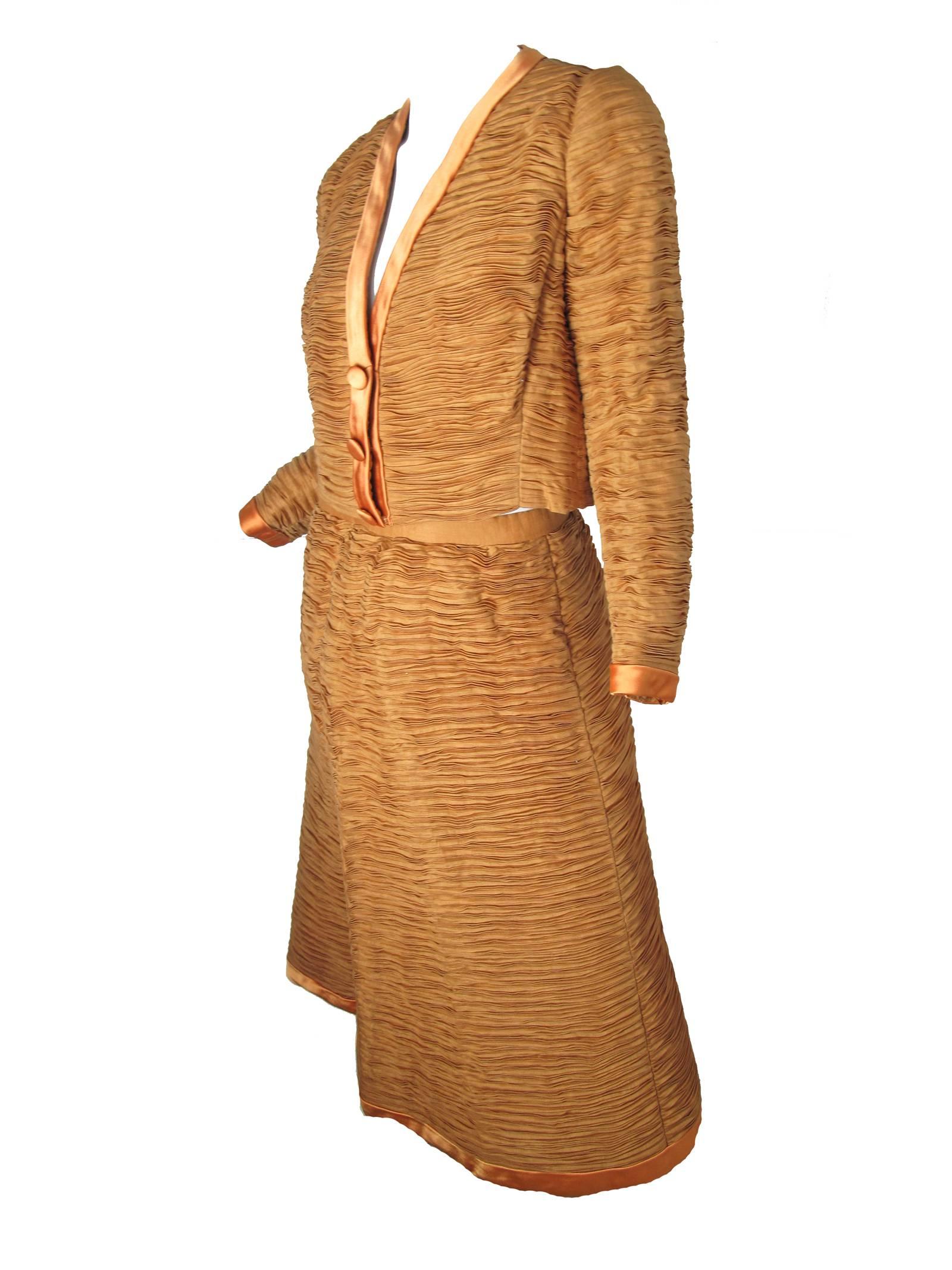 1960s Sybil Connolly Irish linen pleated jacket and skirt with satin trim.  Condition: Excellent. Size Medium

Jacket: 38