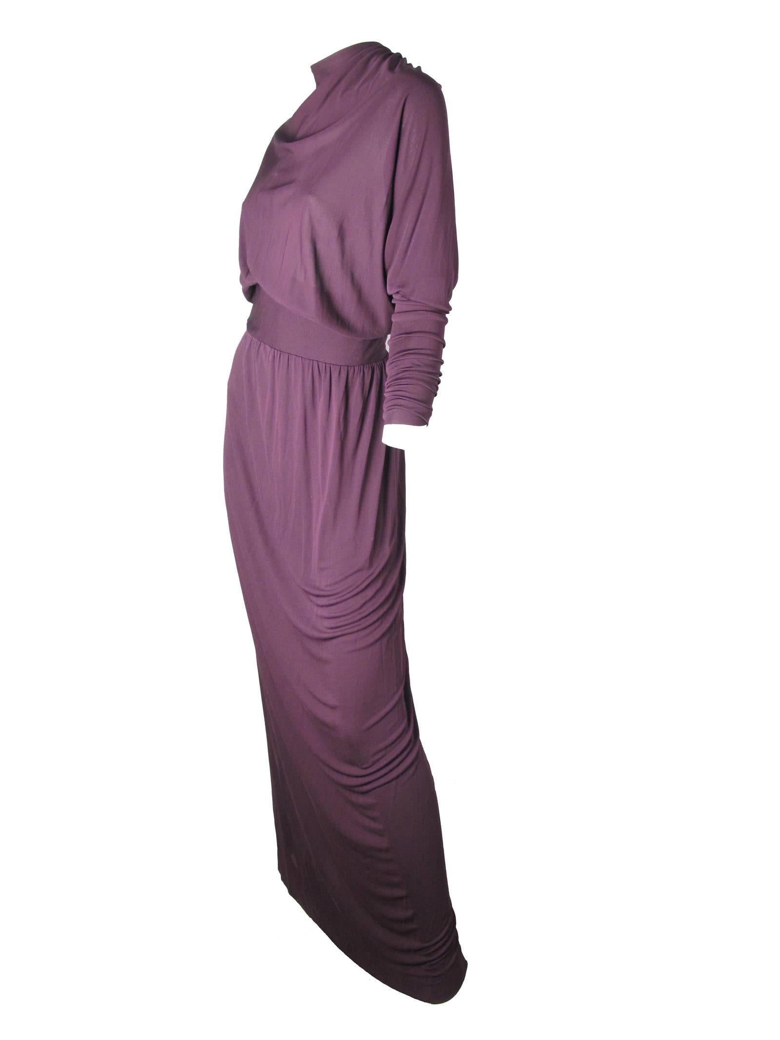 Gorgeous early 70s Givenchy deep purple viscose jersey evening gown with ruching at cuffs and down back.  Condition:  AS IS, some moth holes on front by neck and on some stitching is showing on back by zipper, see photo.  Zipper up back.
Size 8 