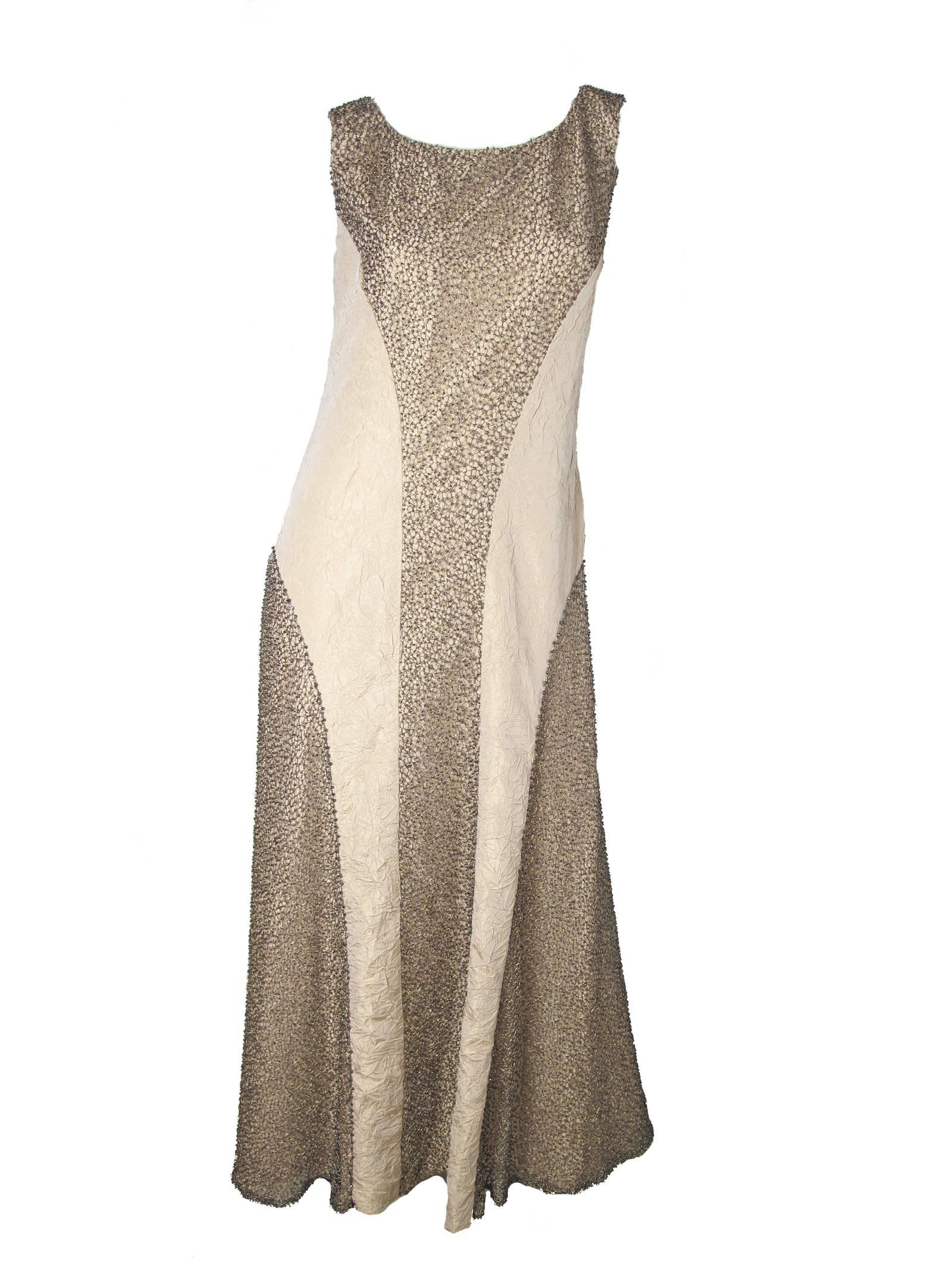 Chanel evening gown with metallic thread and beading c. 2000.  Condition: Very good.  Acetate and silk fabric.  Size 40 /US 6- 8

We accept returns for refund, please see our terms.  We offer free ground shipping within the US.  Please let us know