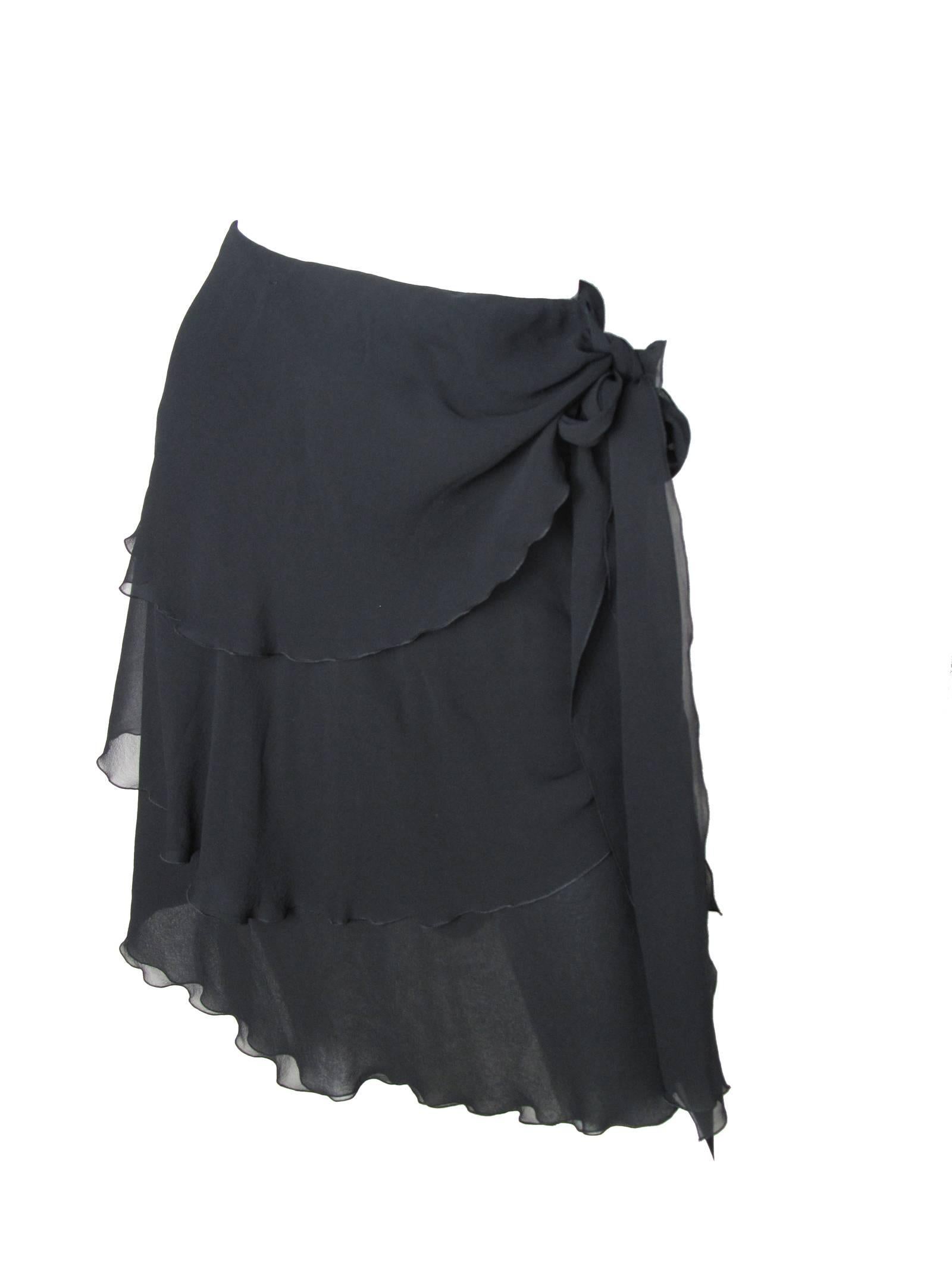 2000 Chanel black silk chiffon ruffle skirt with two ties on side.  Condition: Excellent. Size 36

We accept returns for refund, please see our terms.  We offer free ground shipping within the US.  Please let us know if you have any questions. 
