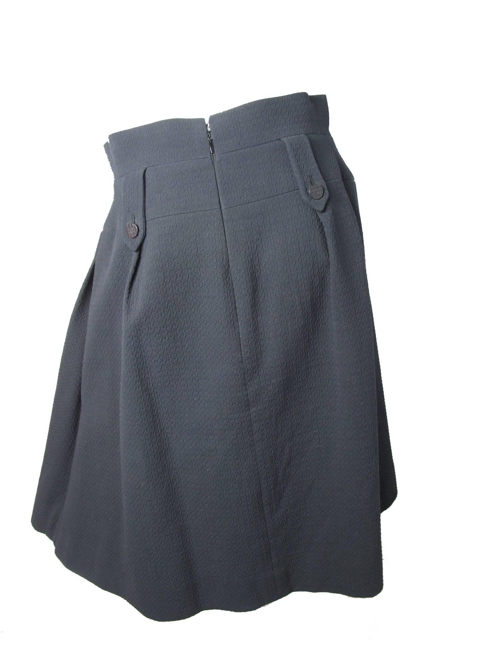 2001 Chanel black cotton dirndl skirt; double tab trim in front and back, high waist, side pockets, Condition: Excellent. Size 42

We accept returns for refund, please see our terms.  We offer free ground shipping within the US.  Please let us