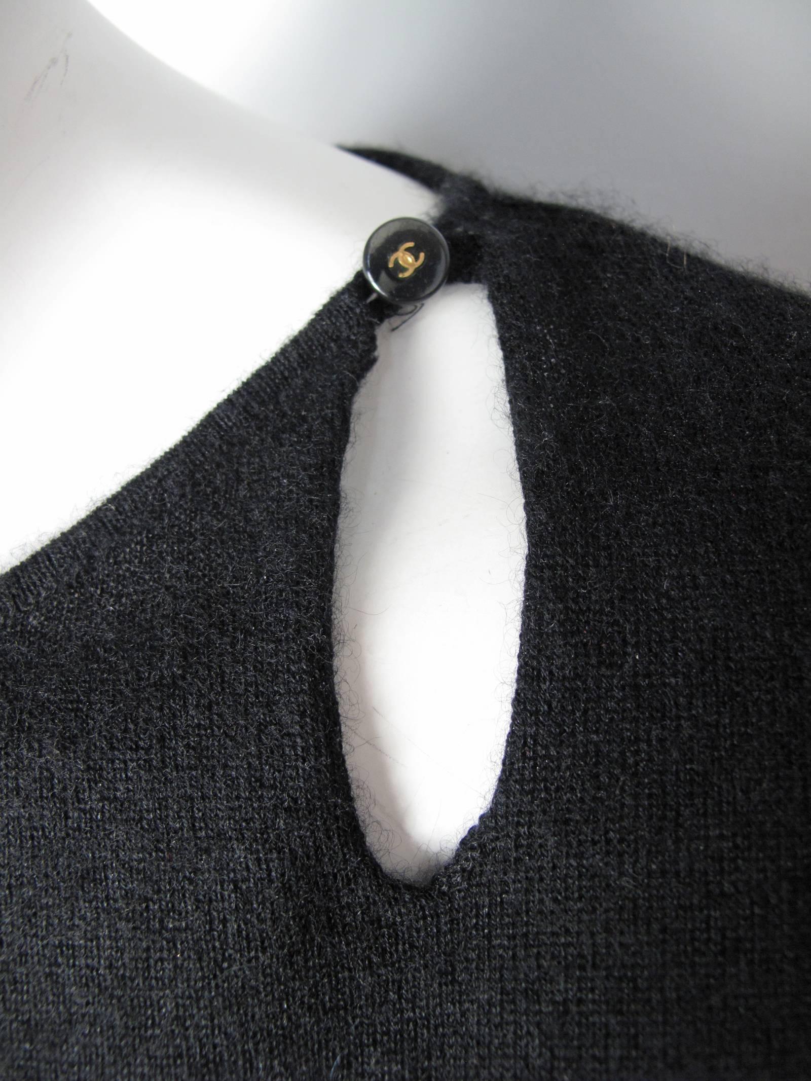Chanel black cashmere sweater with with one button tear drop opening at neck, bell sleeve with one button closure. Condition: Very good. Size 42
We accept returns for refund, please see our terms.  We offer free ground shipping within the US. 