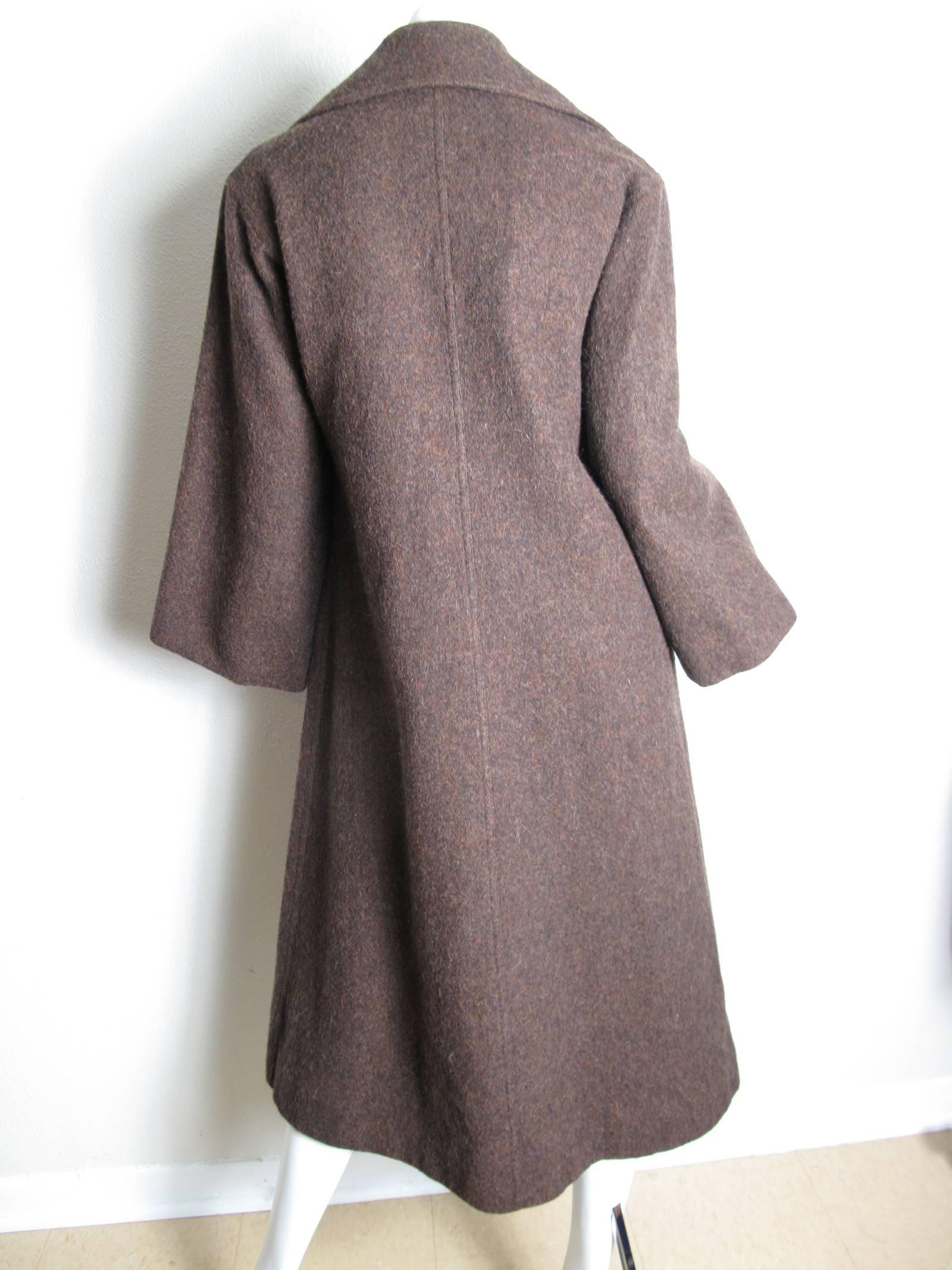1960s brown wool coat with two front pockets. Unlined. Condition: Excellent. Size M / L

We accept returns for refund, please see our terms.   We offer free ground shipping within the US.  Please let us know if you have any questions.
