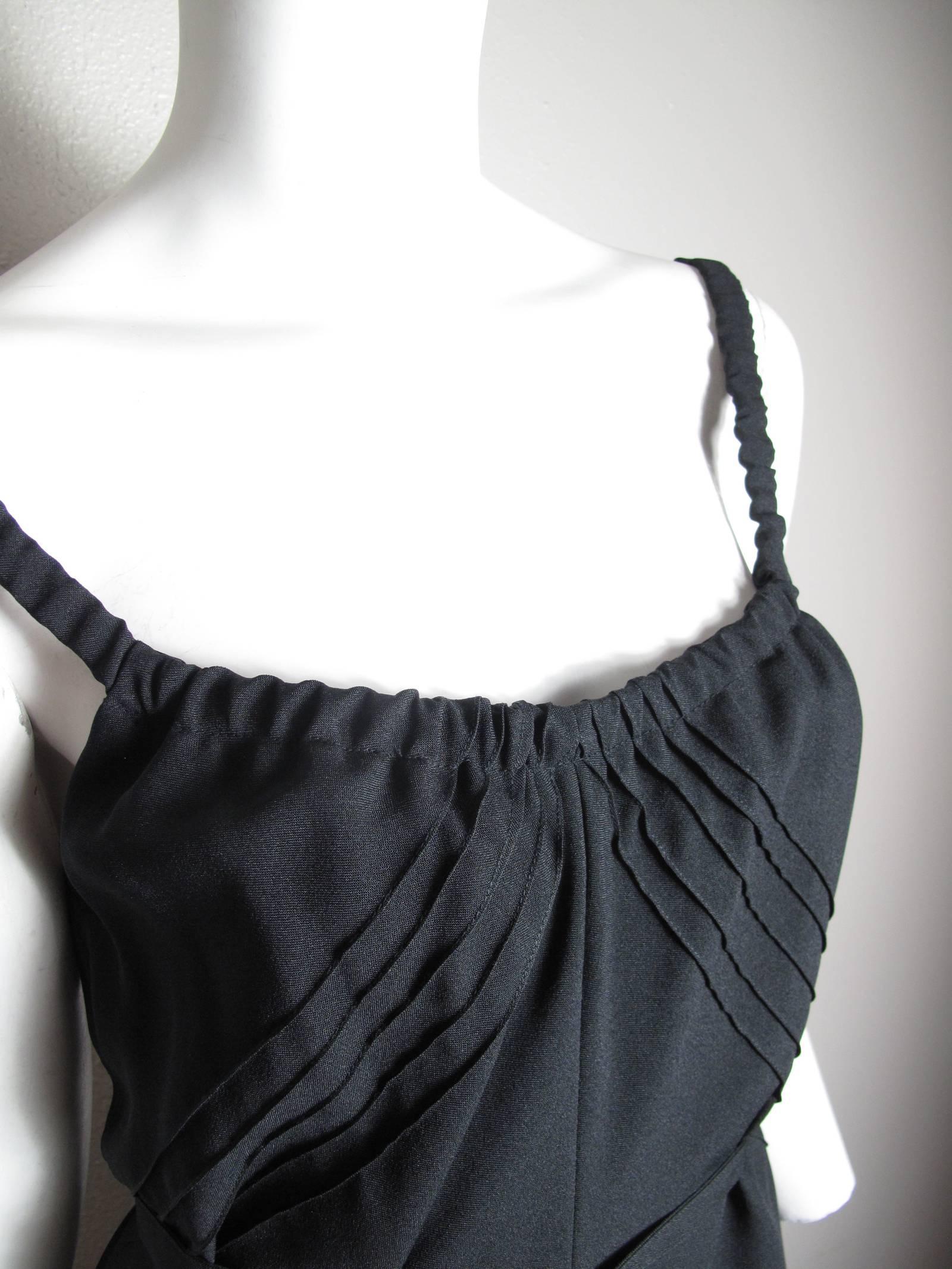 Nipon boutique black dress with ruffle trim and elastic straps.  Condition: excellent. Size 8

We accept returns for refund, please see our terms.  We offer free ground shipping within the US.  Please let us know if you have any questions.
