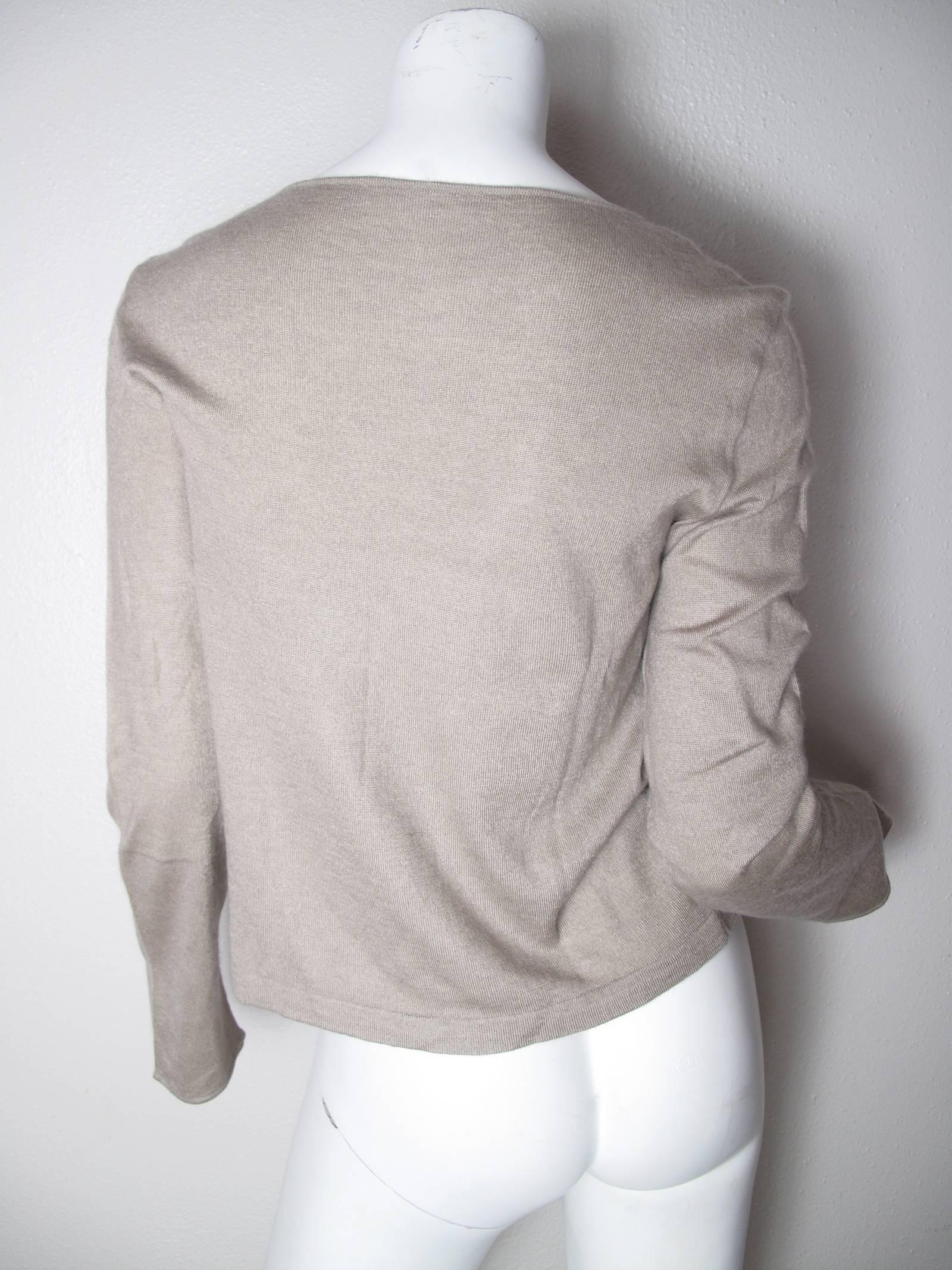 Chanel beige cashmere pull over sweater.  Chanel metal tag on front.  Condition:Very good - missing Chanel inside label.  
Size 42

