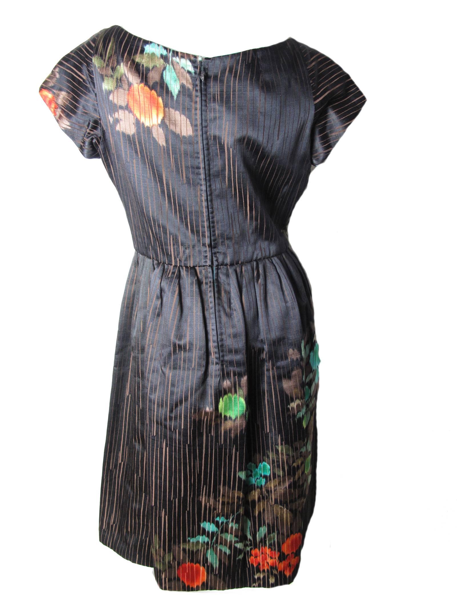 1950s Catherine Scott black satin cocktail dress with floral and stripe pattern. Condition: Excellent. Size 8

We accept returns for refund, please see our terms. We offer free ground shipping within the US. Please let us know if you have any
