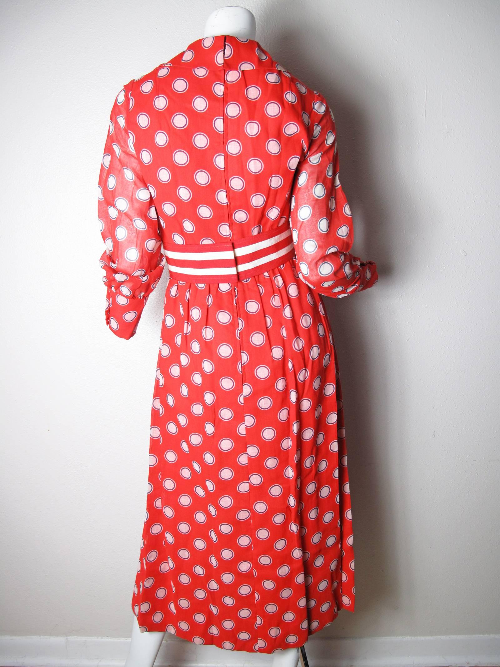 1970s Mollie Parnis Boutique sheer red, white and blue polka dot gown, lined.  Cotton type fabric.  With striped belt and side pockets. Condition: Good, small dark spot on belt. Size small - med

We accept returns for refund, please see our terms.