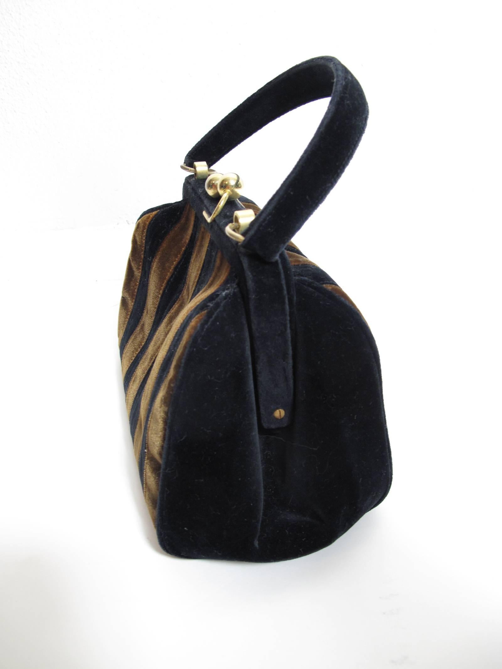 1960s Fendi velvet striped bag with ball closure.  Condition: Very good, some patina to metal.  
We accept returns for refund, please see our terms.  We offer free ground shipping within the US.  Please let us know if you have any questions.