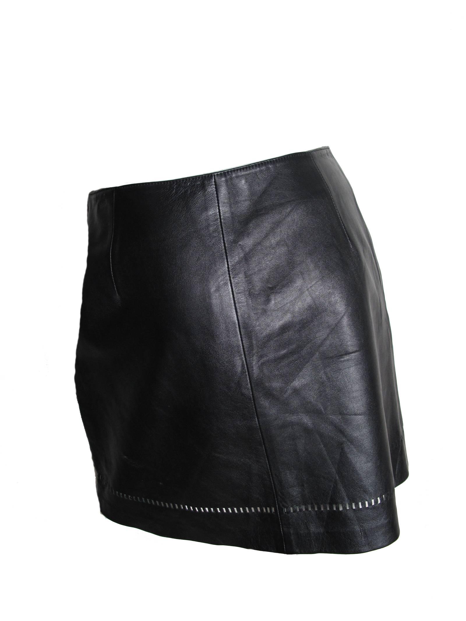 Versus black leather skirt with cut outs at hem. Condition: Very good.  Size 44

We accept returns for refund, please see our terms.  We offer free Ground Shipping within the US.  Please let us know if you have any questions. 
