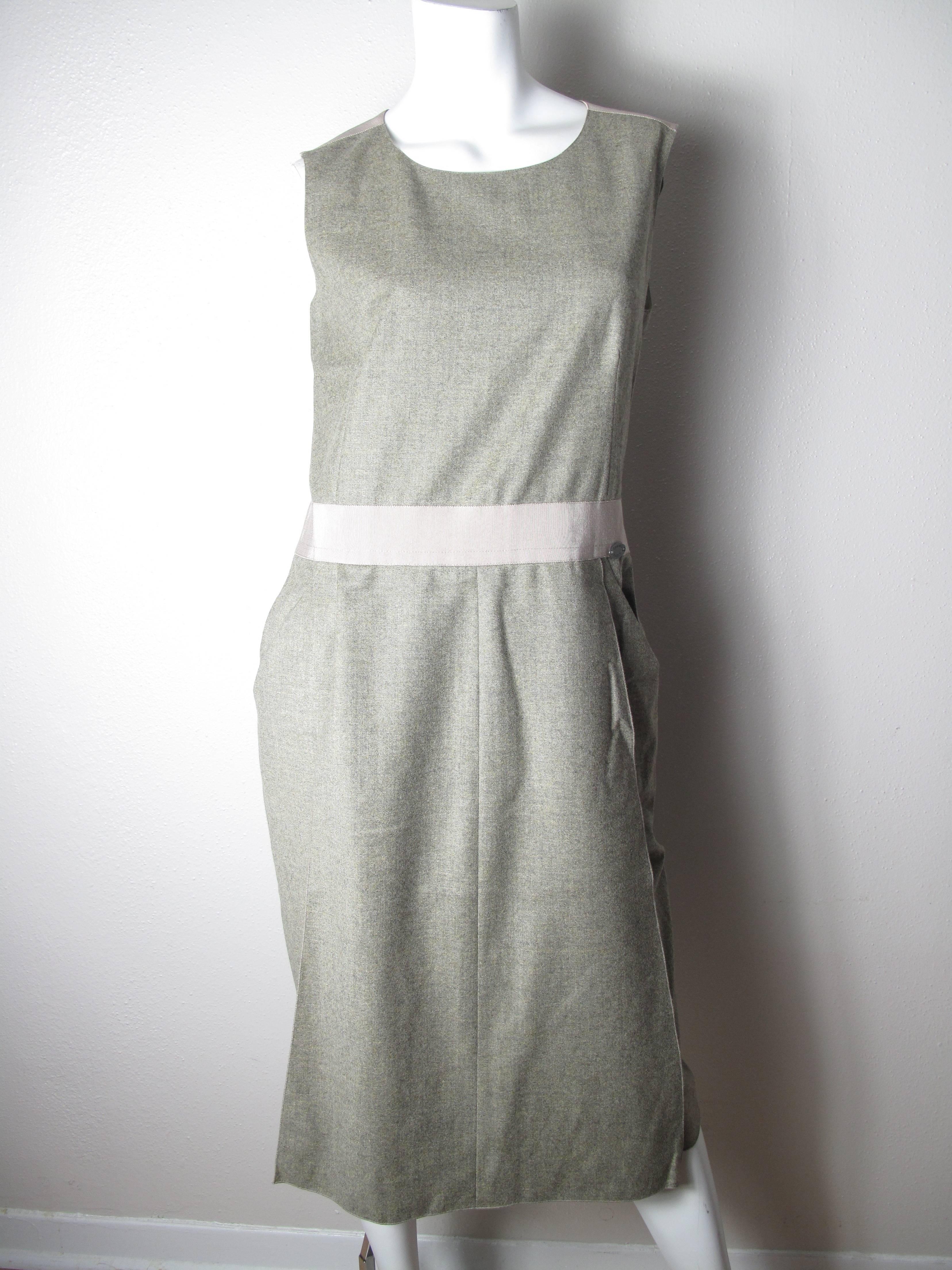 Chanel 1999 greenish / grey wool and cashmere dress with grosgrain shoulders and at waist. Two front pockets. Condition: Excellent.  Size 40 
Back zip, 2 panels overlay front and back.
We accept returns for refund, please see our terms. We offer