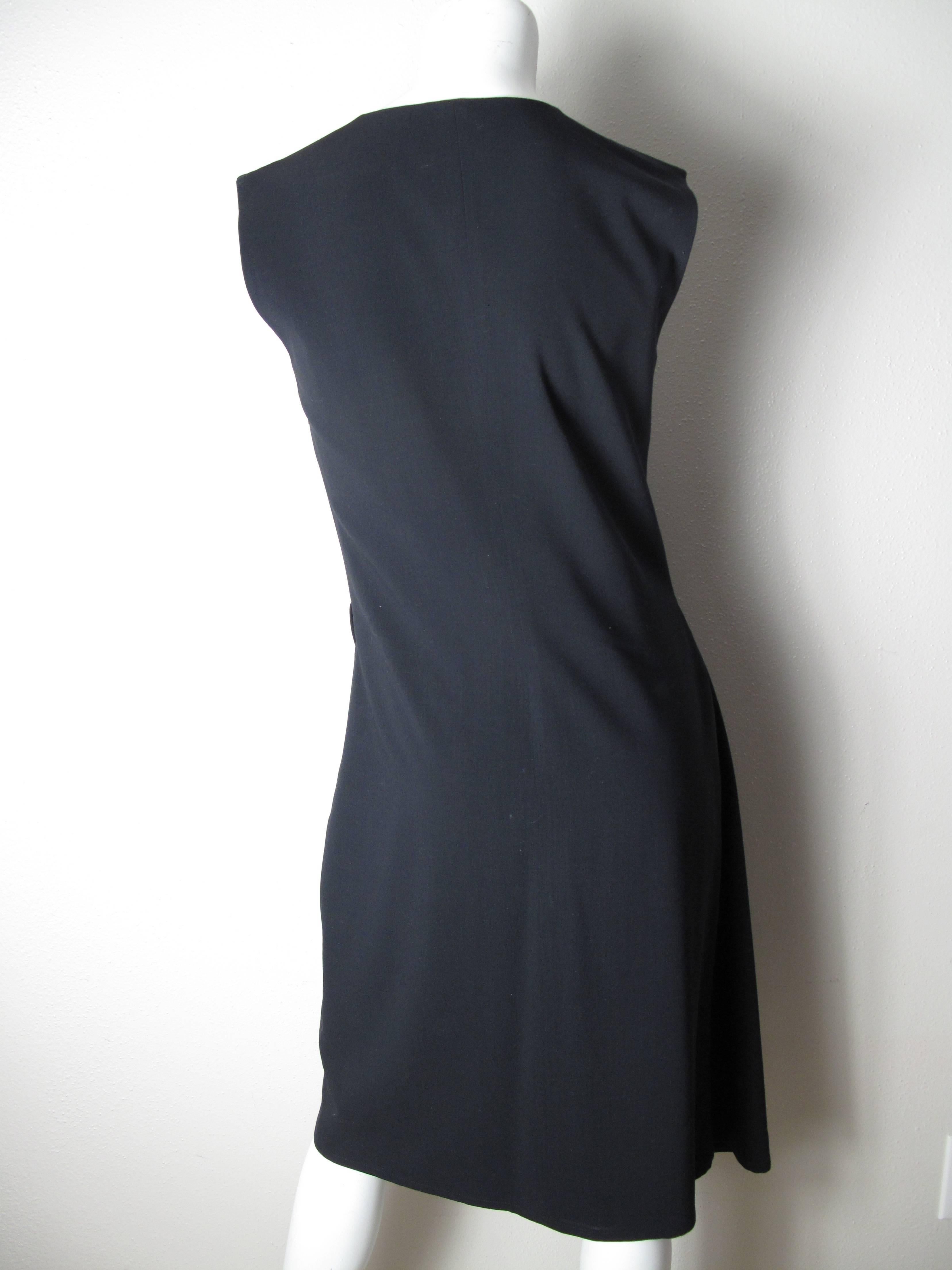   Jil Sander navy wool gabardine sleeveless dress, wrap/tie ½ front, Size 38.
Condition: Excellent. Zipper on side.
We accept returns for refund, please see our terms. We offer free ground shipping within the US. Please let us know if you have any