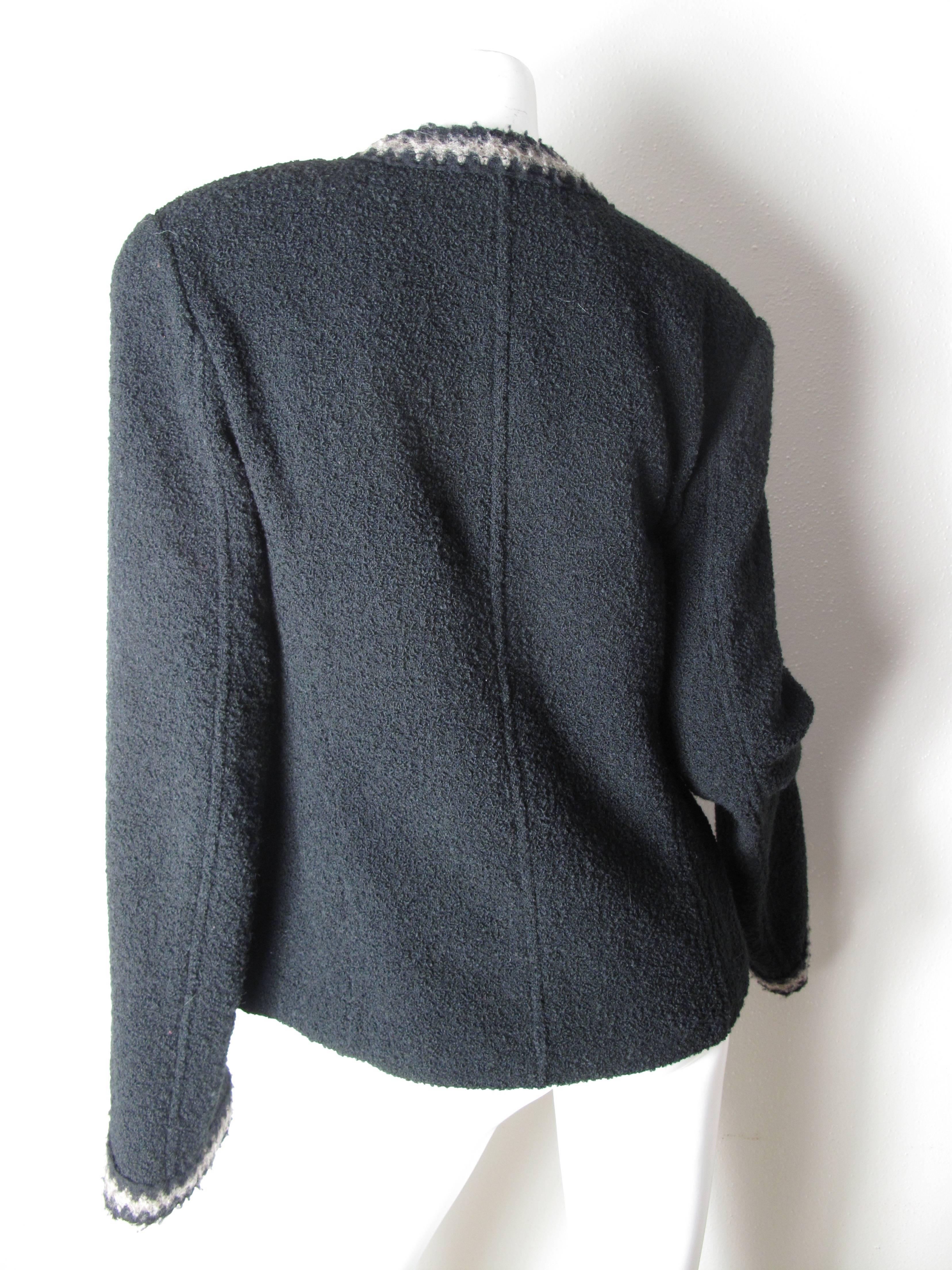 Chanel black boucle jacket, one button front closure, 40, taupe zig-zag trim down front, around collar, pockets, and cuffs, welt seaming, 40
Condition: Excellent.
We accept returns for refund, please see our terms.  We offer free ground shipping