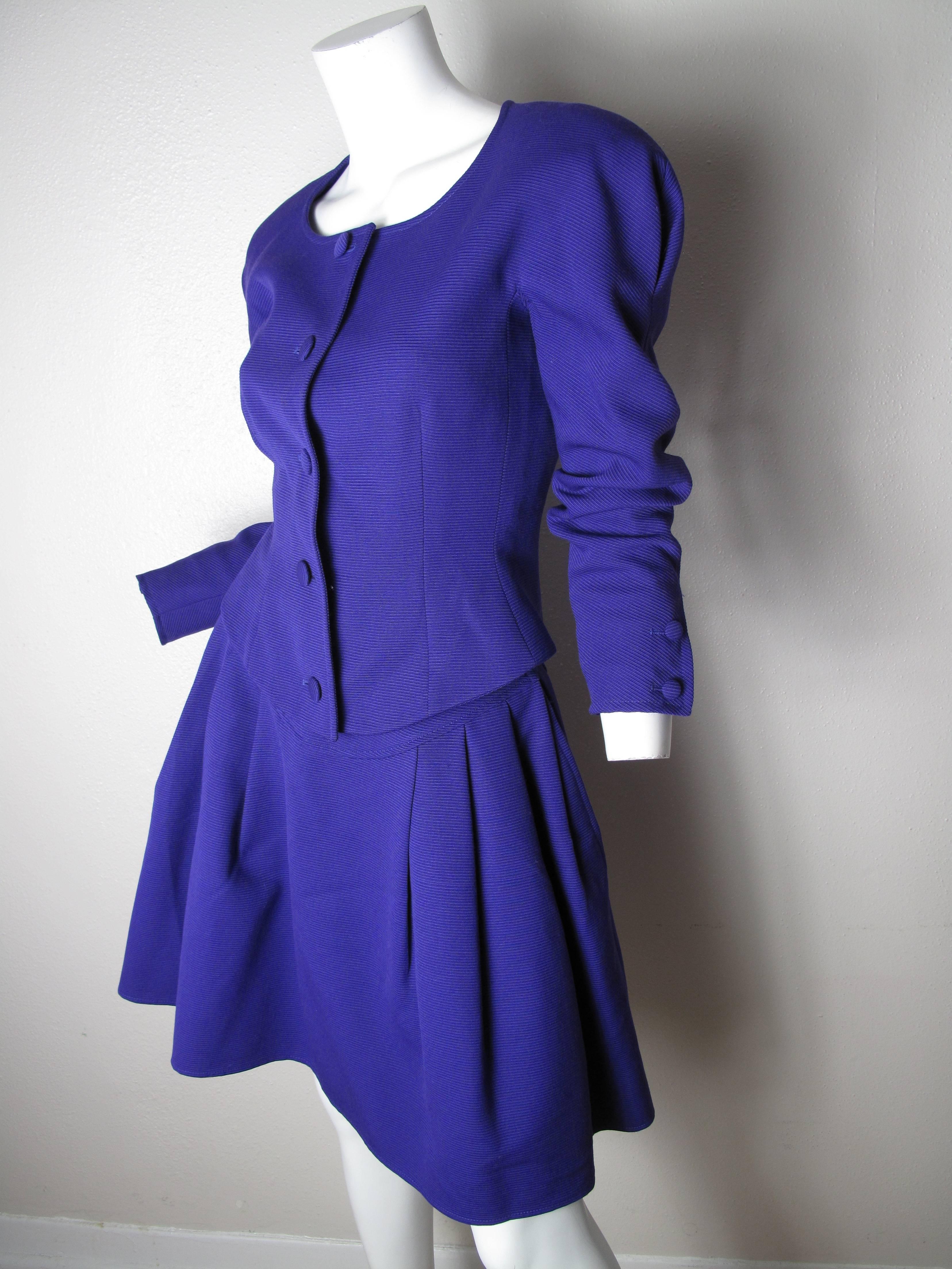 1990s Christian Lacroix purple suit.  Fitted jacket with buttons down front. Flare skirt with pockets. Condition: good, two spots on front of jacket, see photos.
Size 6
We accept returns for refund, please see our terms. We offer free ground