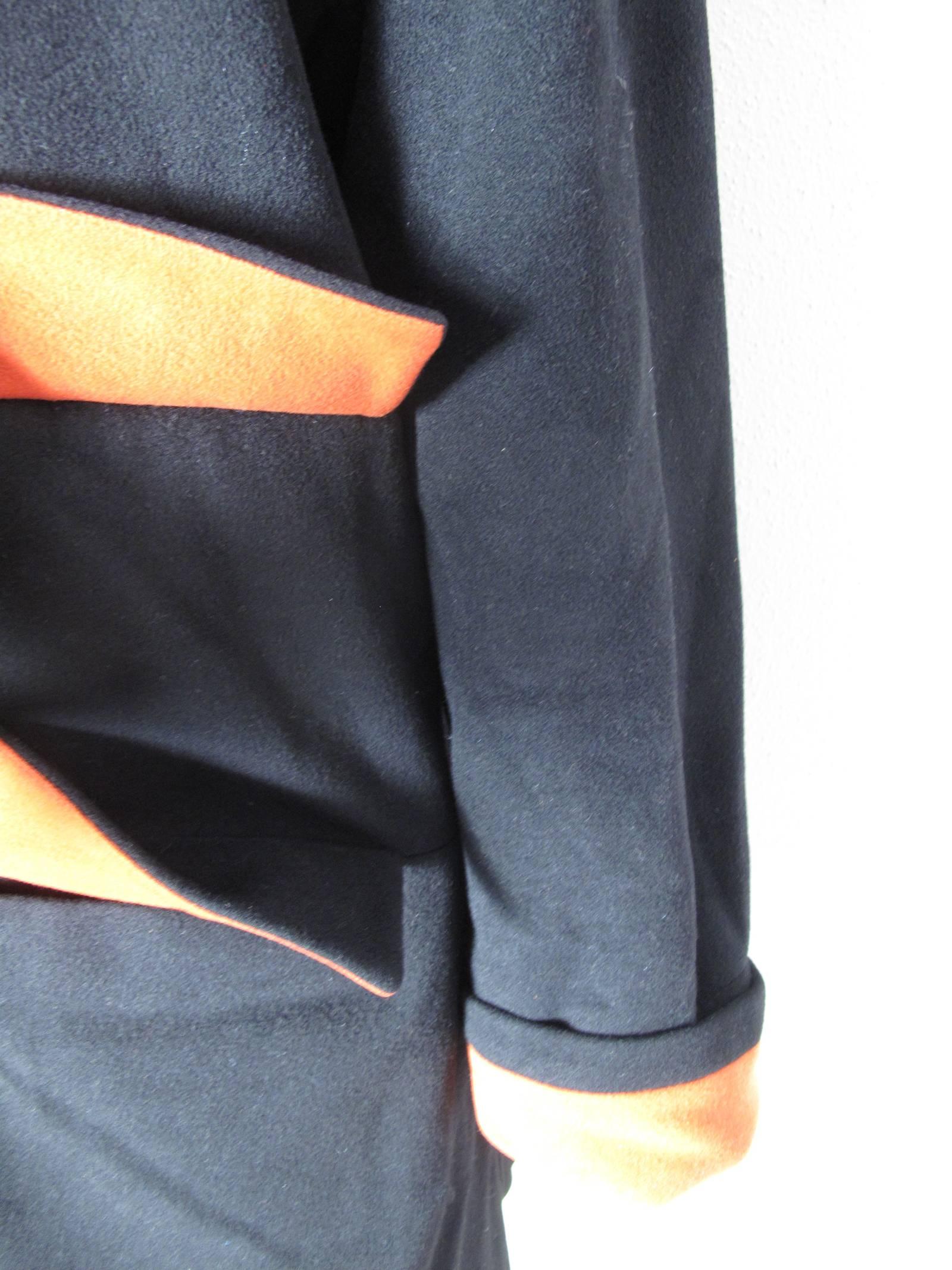 1980s Karl Lagerfeld black wool coat with orange/red under collar, pockets and cuffs. Condition: Excellent. 
Size 6 
We accept returns for refund, please see our terms.  We offer free ground shipping within the US.  Please let us know if you have