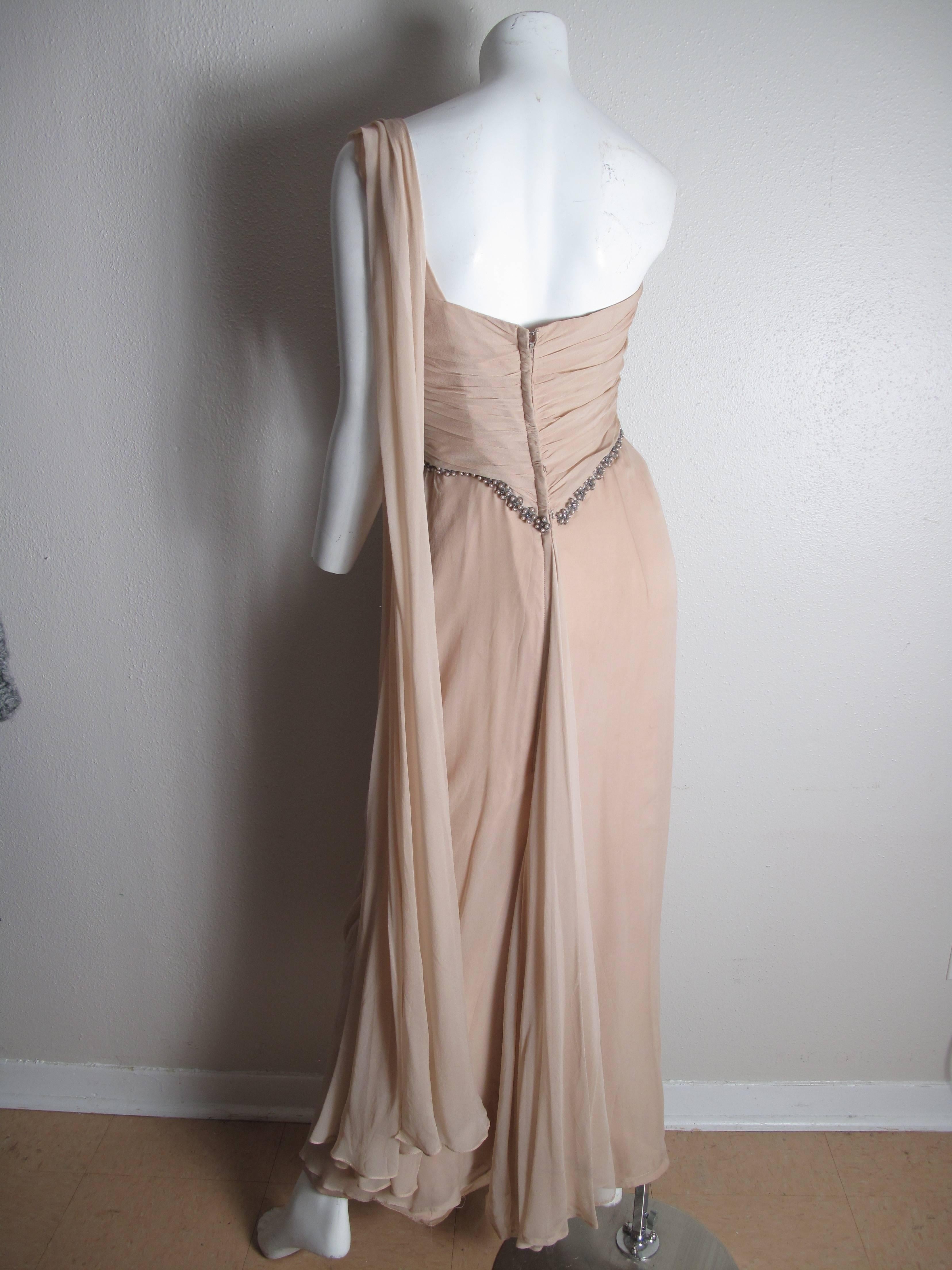 Emma Domb one shoulder chiffon gown with faux pearl, beading and rhinestone trim.  Condition: Good, some spots.  
Label Size 14/ fits current size 8 - 10 
We accept returns for refund, please see our terms.  We offer free ground shipping within the