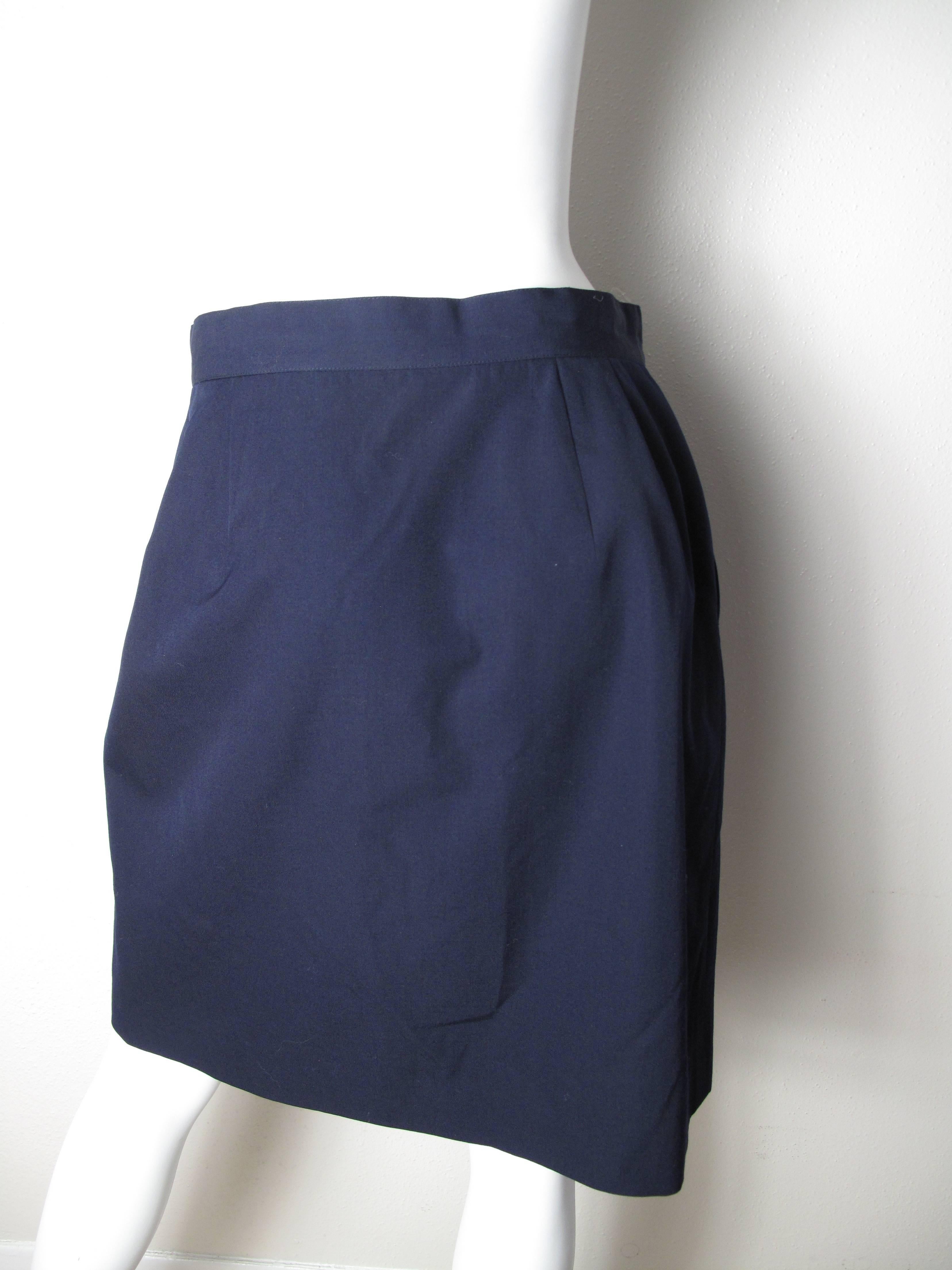 Issey Miyake navy wool wrap skirt, one pocket.  Condition: Excellent. Size M

We accept returns for refund, please see our terms.  We offer free ground shipping within the US.  Please let us know if you have any questions. 