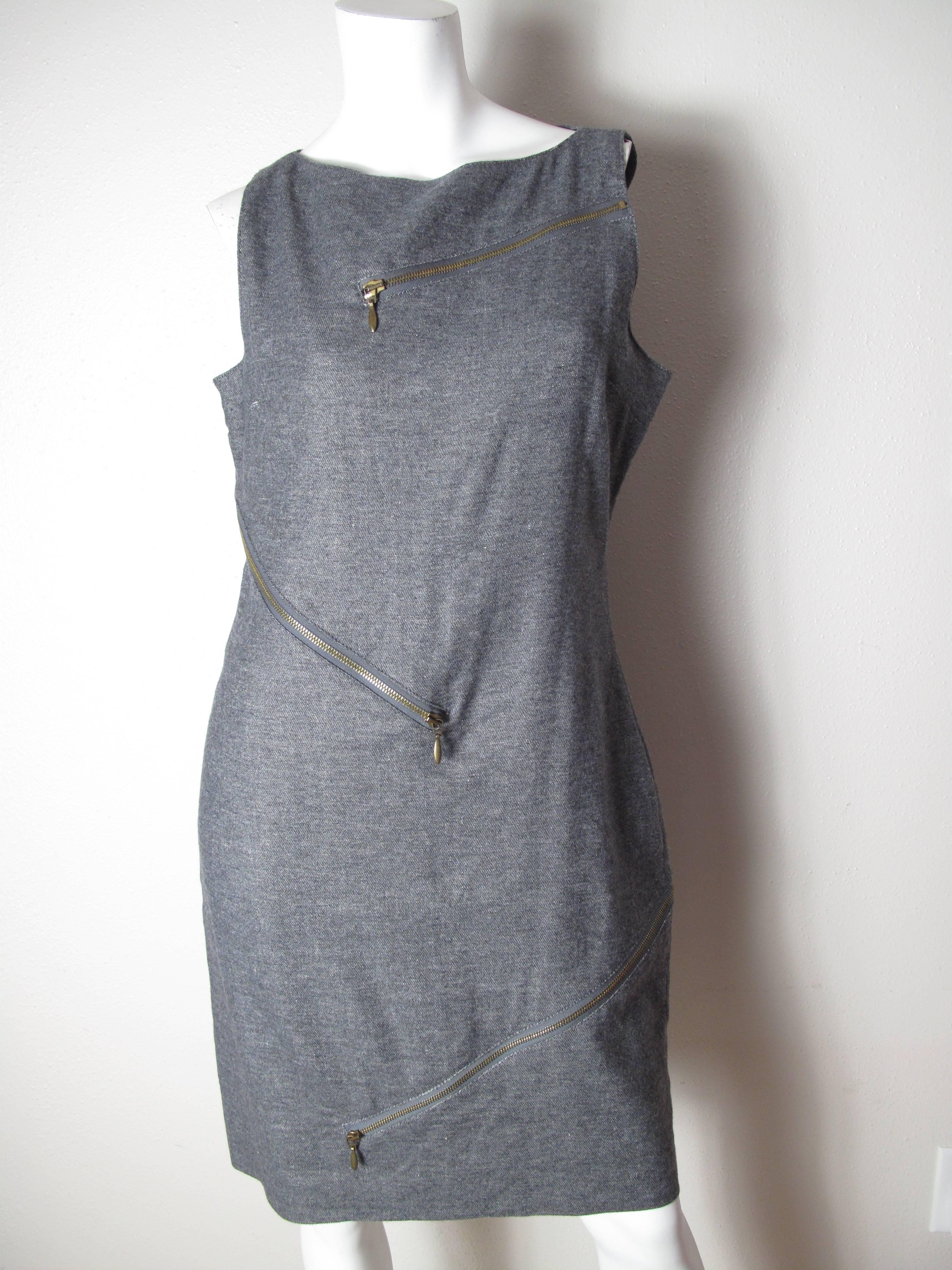 McQueen grey wool dress with zippers.  Condition: Excellent. 
Size 8 / 10
We offer free ground shipping within the US.  We accept returns for refund, please see our terms.  Please let us know if you have any questions. 