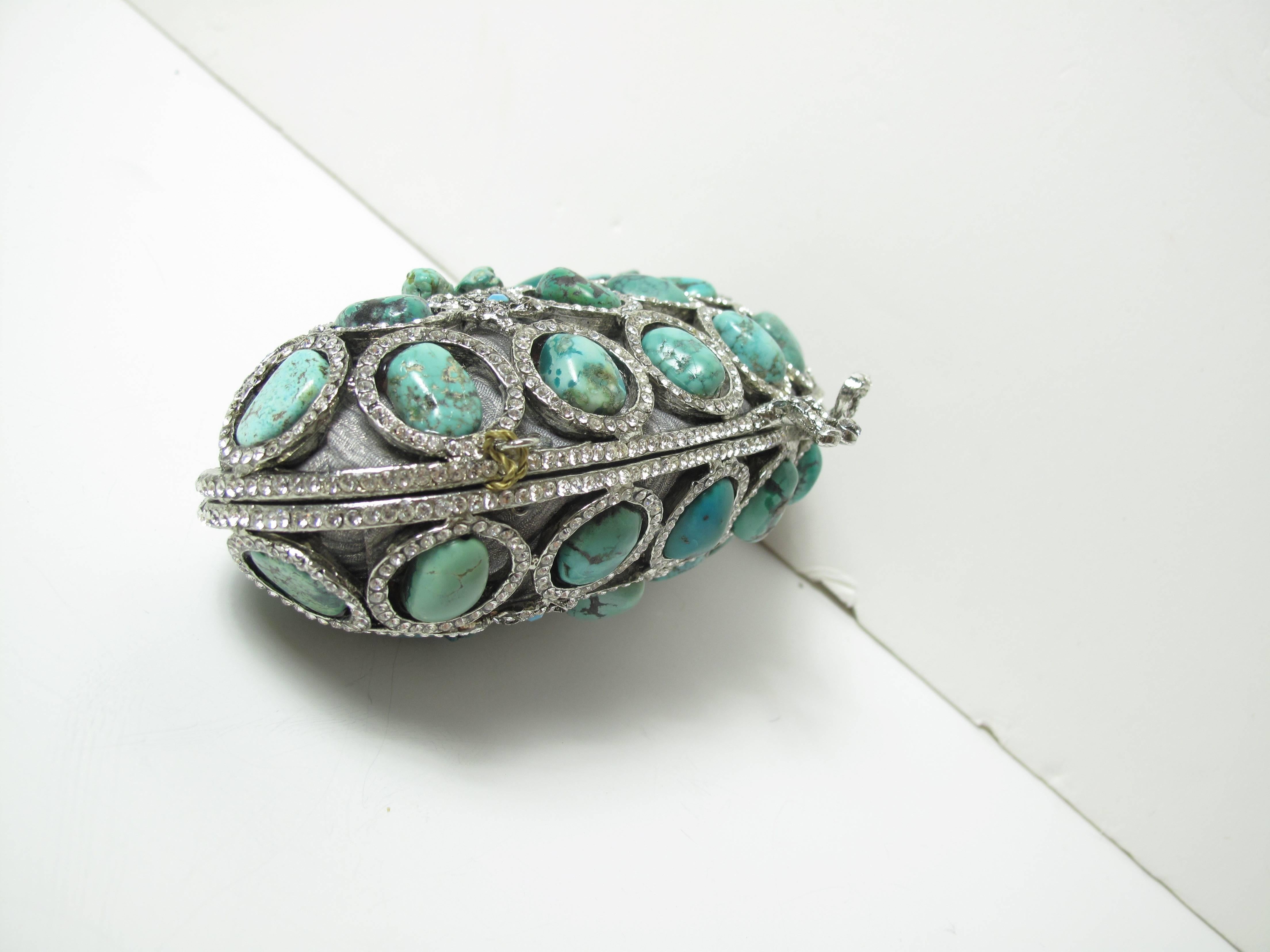 Edidi turquoise and Swarovski crystal evening bag. 

Small diamantes and jade beading set on beautiful ribbon-like silver design.
Beaded jade double strand handle is removable adding versatility to this clutch/handbag.
Lined in fine silver