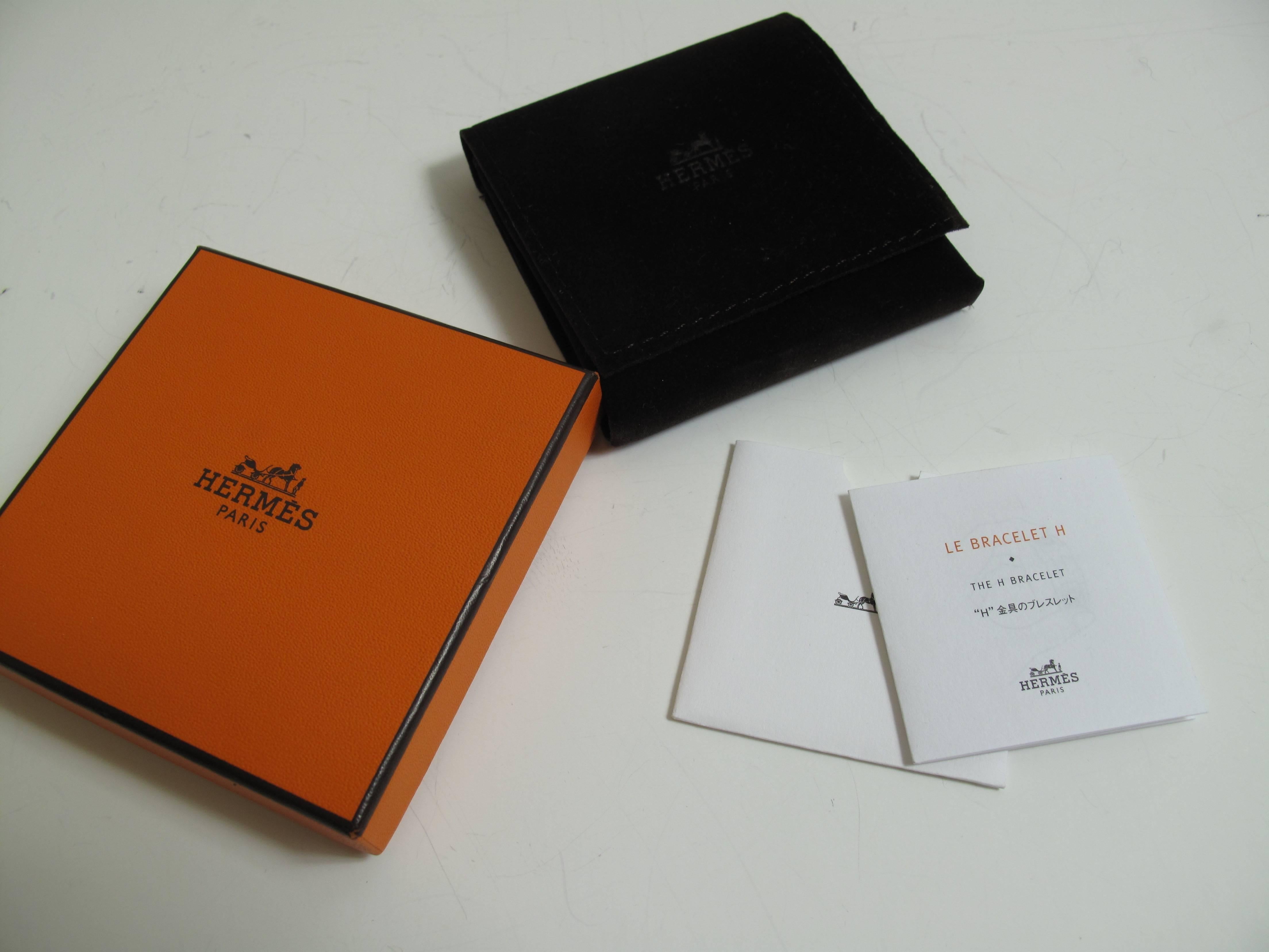 Hermes Orange enamel H Bracelet with box and velvet pouch.  Condition: Excellent
2.25