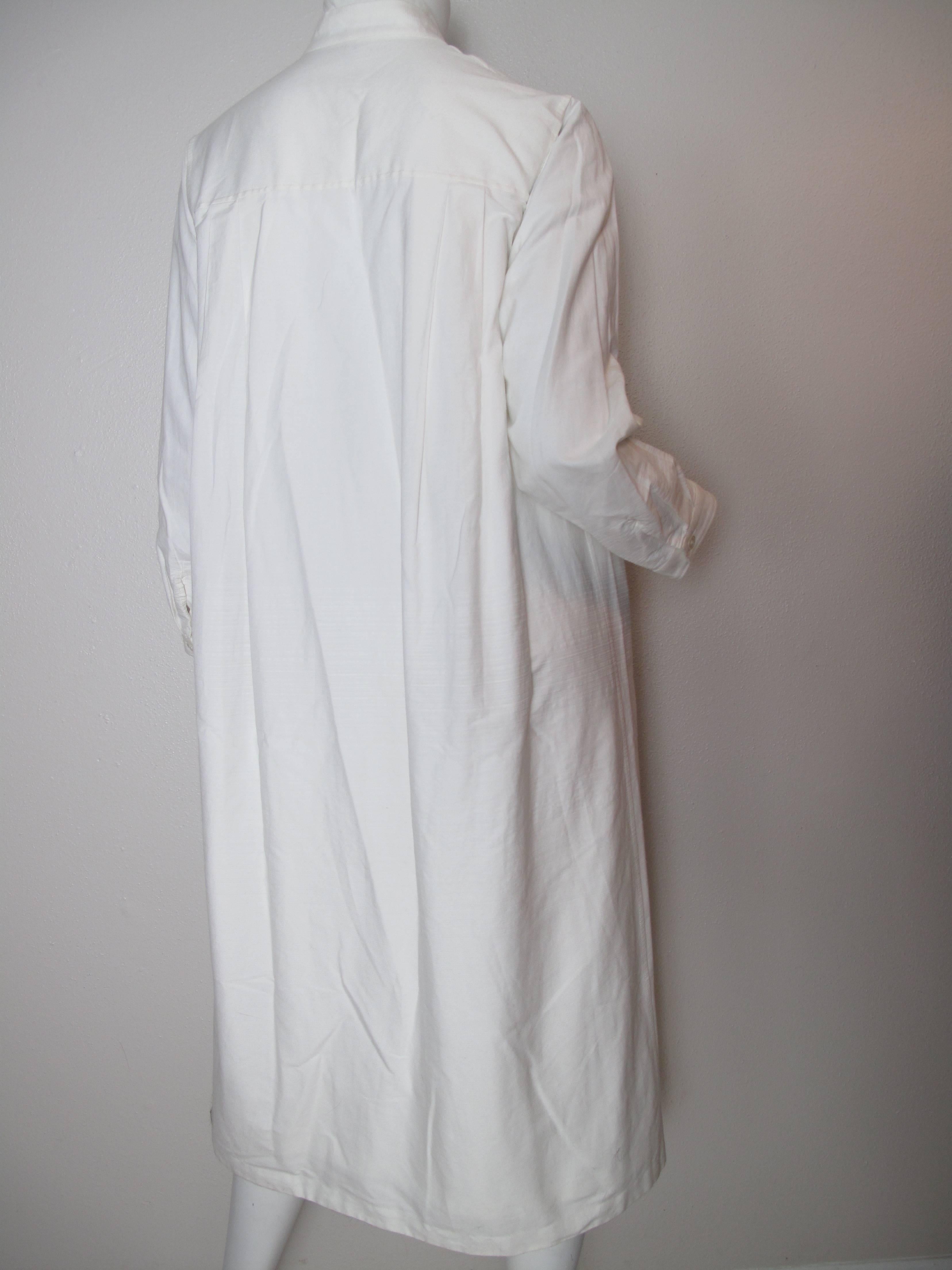 Issey Miyake white cotton/ poly long button down shirt dress.  Condition: Good, some wear.  Size 3
We accept returns for refund, please see our terms.  We offer free ground shipping within the US. Let us know if you have any questions. 
