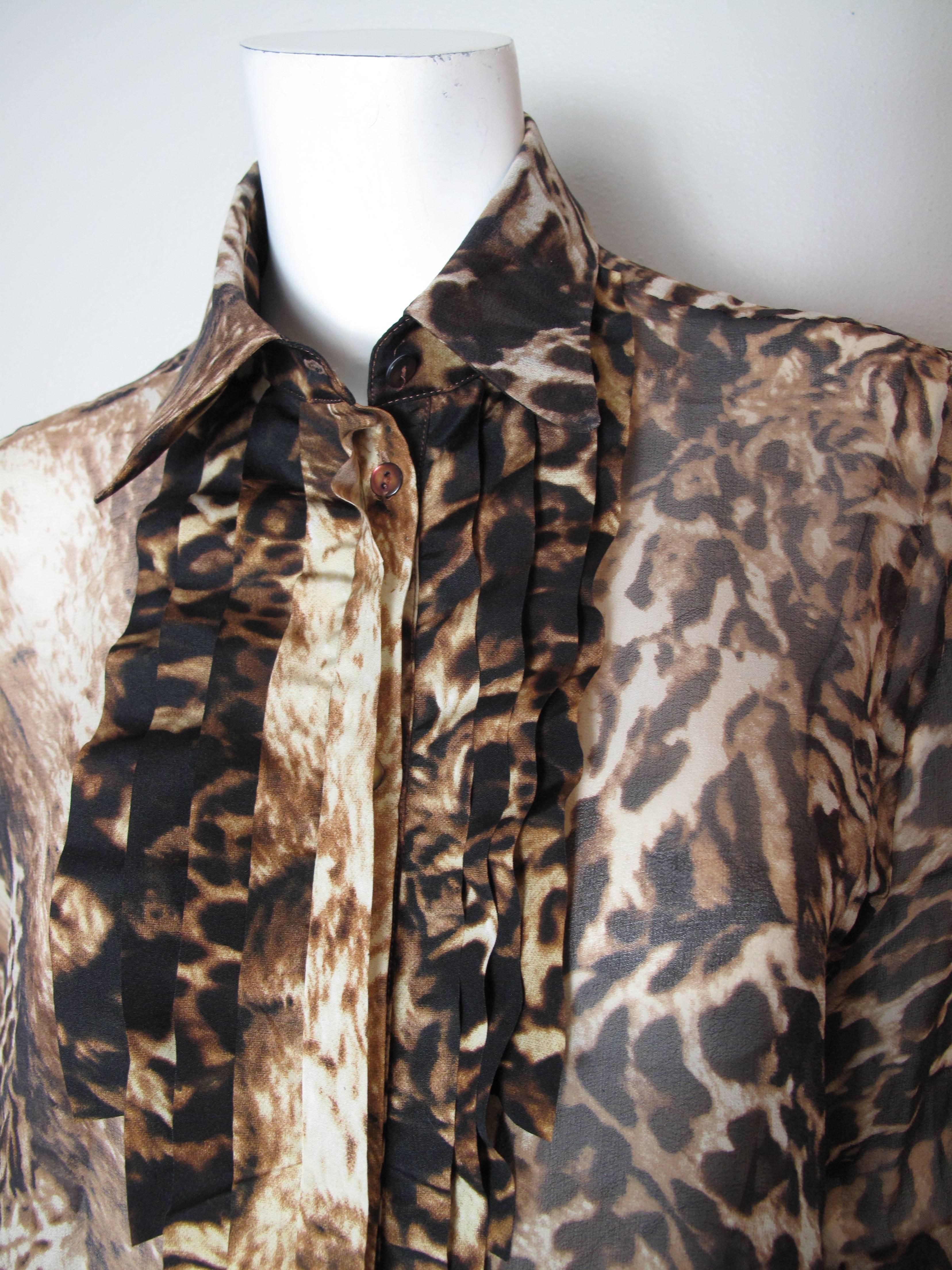 Kenzo sheer poly leopard ruffle blouse.  Condition: Excellent. Size  42

We accept returns for refund, please see our terms.  We offer free ground shipping within the US. Let us know if you have any questions. 