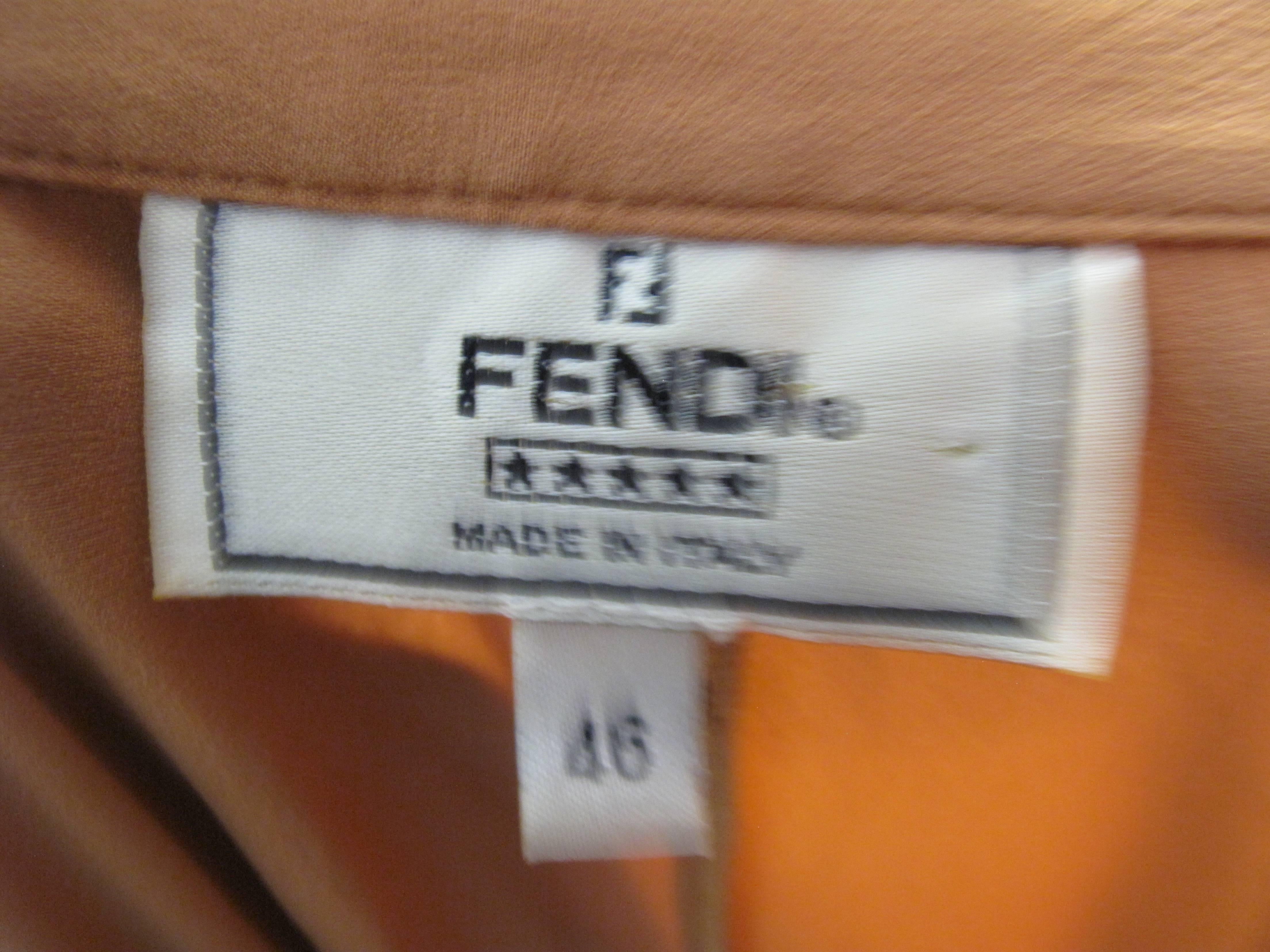 Fendi silk and spandex  top with buttons down front, rusching on sides.  Condition: Excellent. Size 46 ( mannequin is a US size 6 )

We accept returns for refund, please see our terms.  We offer free ground shipping within the US