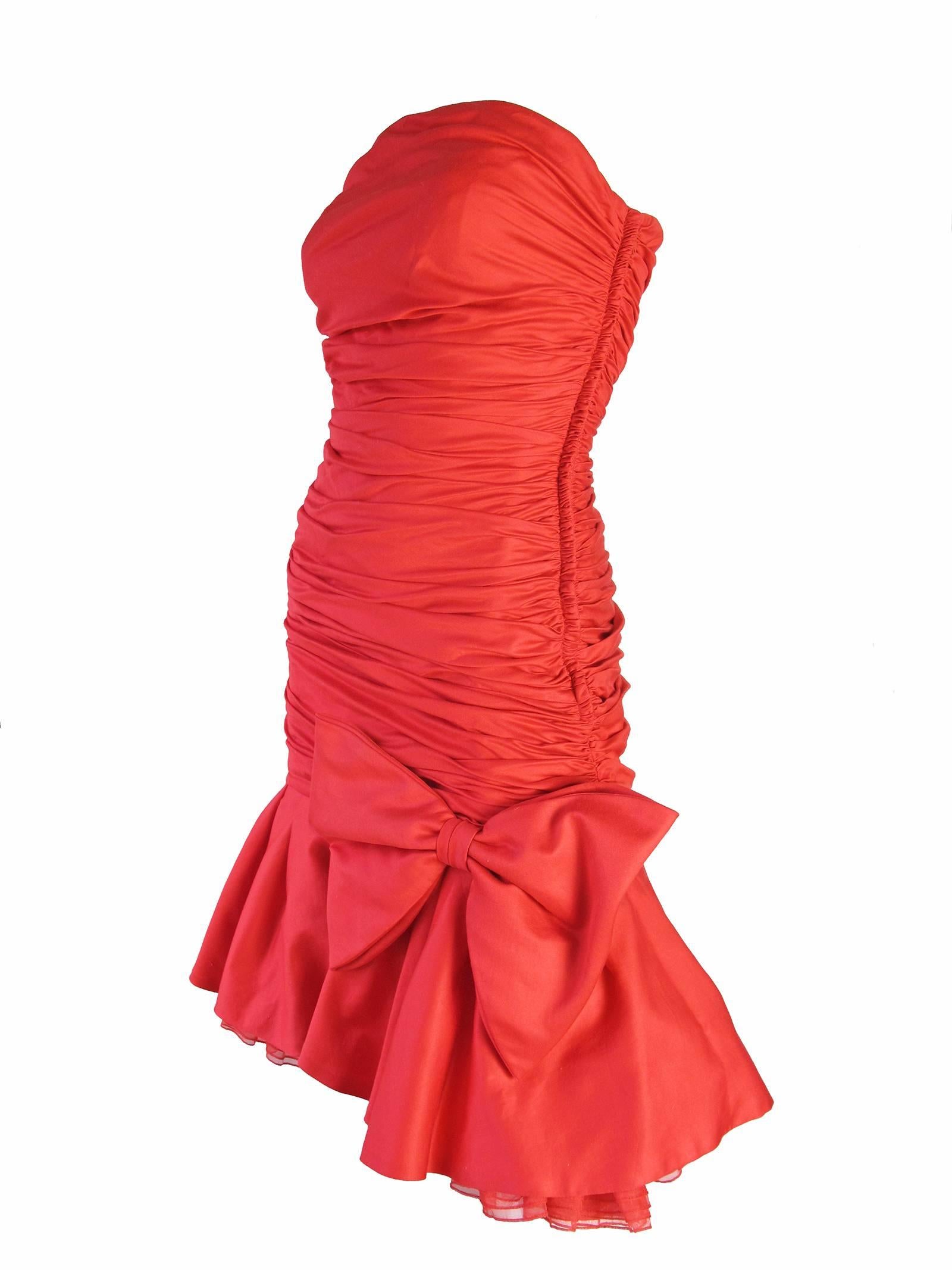 1980s Christian Dior strapless red dress with ruffle and bow.  Cotton fabric. Zipper up side and boning inside down front..  Condition; Excellent. Size 4/6

We accept returns for refund, please see our terms.  We offer free ground shipping within