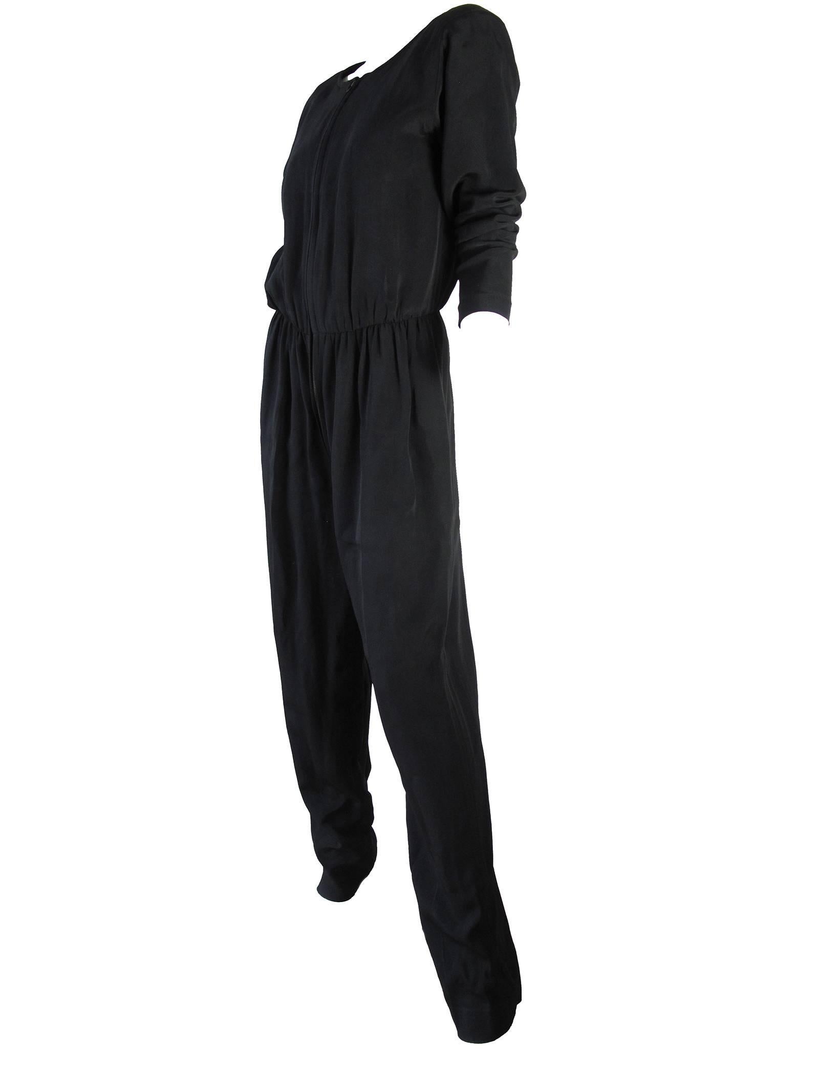 Yves Saint Laurent black jumpsuit.  Zipper down front, elastic waist. Condition: good, some all over wear.  Size M (mannequin is a us size 6)

We accept returns for refund, please see our terms.  We offer free ground shipping within the US.  Please